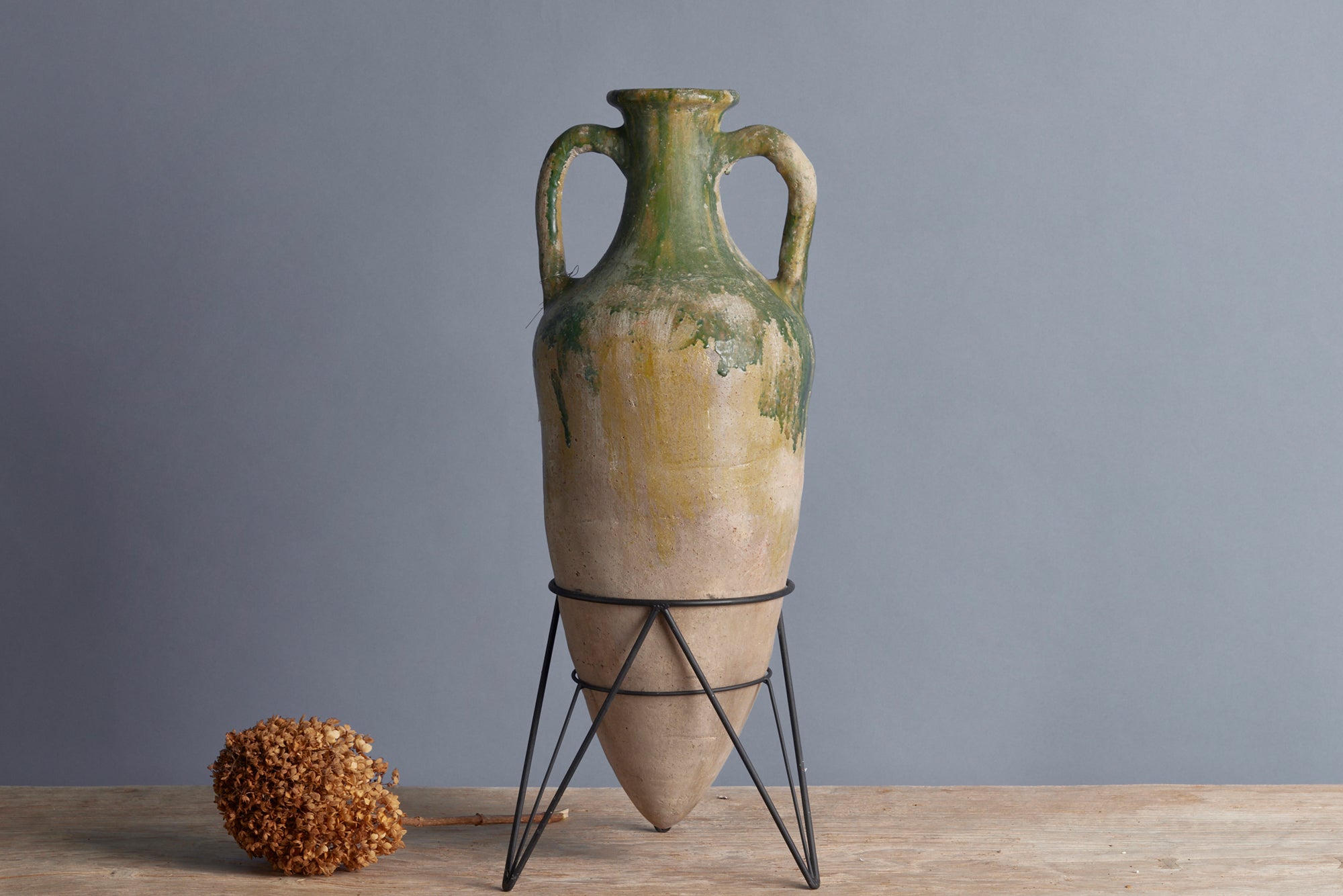Handmade Green Glaze Stoneware Amphora Vase with Iron Tripod Stand - Borneo Island Ceramic Art Piece for Home Decor, Wedding Centerpiece & Mediterranean Style Interior Design