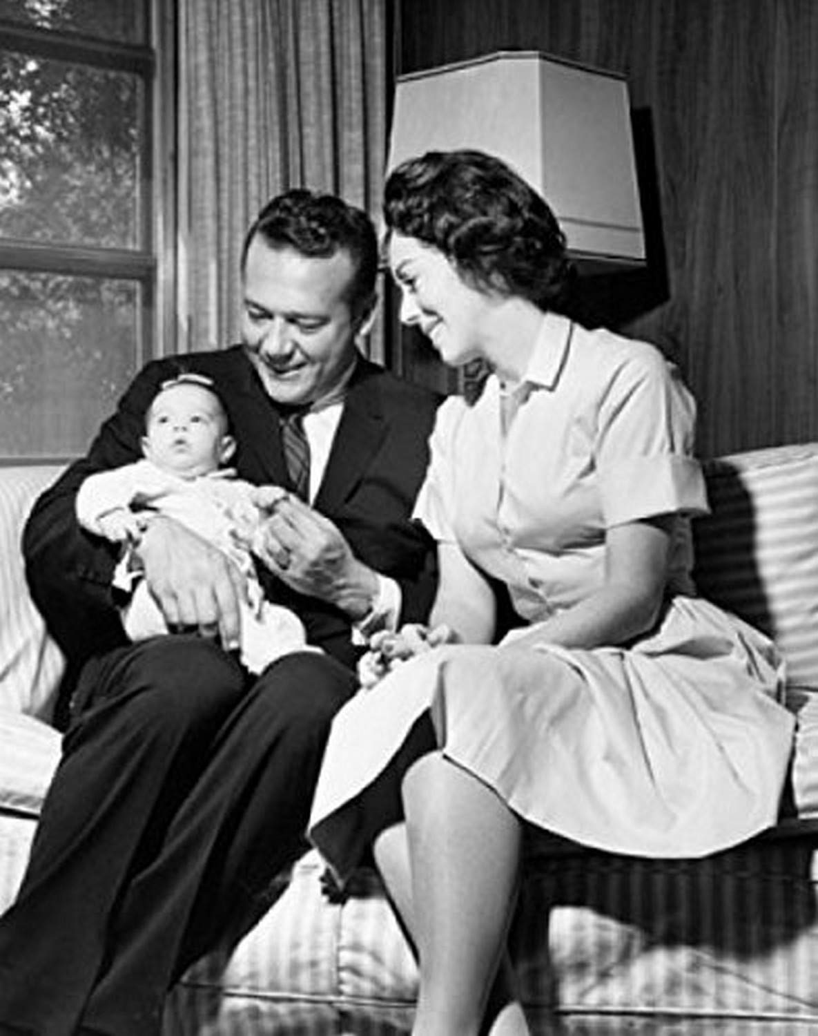 Mid Adult Couple Sitting on Couch with Baby - 18x24 Inch Wall Art Poster Print - Perfect for Nursery, Living Room & Family Home Decor