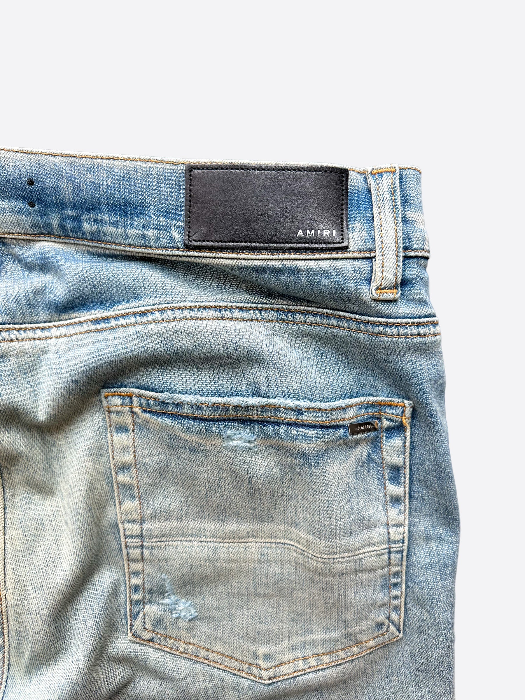 Amiri Blue Distressed Jeans with Multicolor Patches - Stylish Ripped Denim Pants for Men | Perfect for Casual Outfits, Streetwear & Night Out Looks