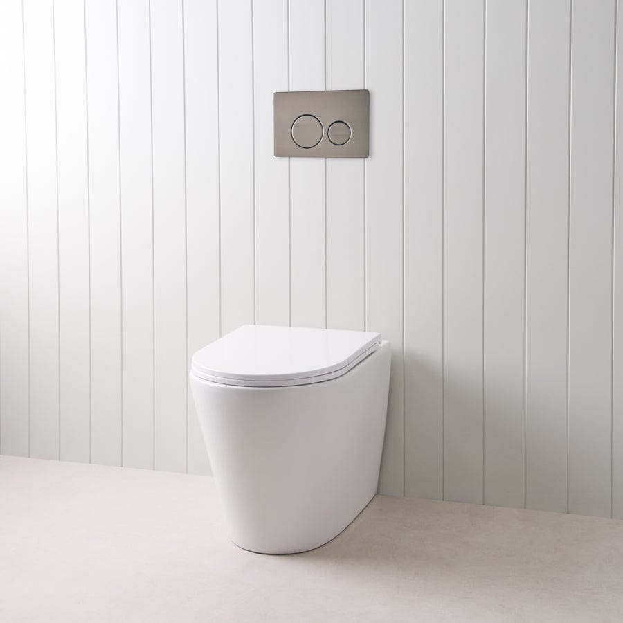 Angled In-Wall Toilet with Round Gunmetal Buttons - Modern Space-Saving Design for Small Bathrooms and Commercial Spaces
