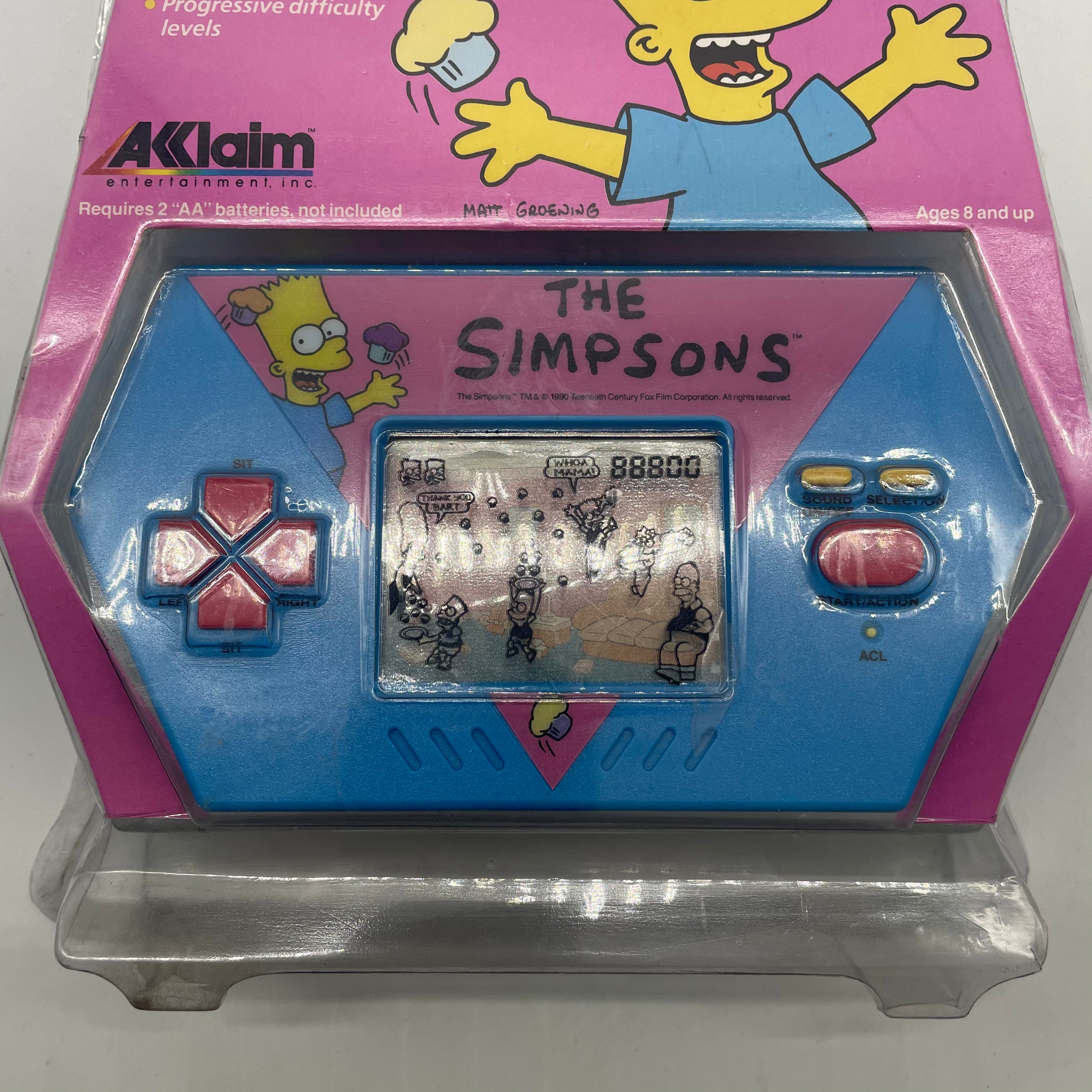 Bart Simpson Cupcake Crisis Handheld Electronic Video Game Console - Retro 1989 Classic Game for Kids & Collectors - Perfect for Travel, Parties & Nostalgic Fun