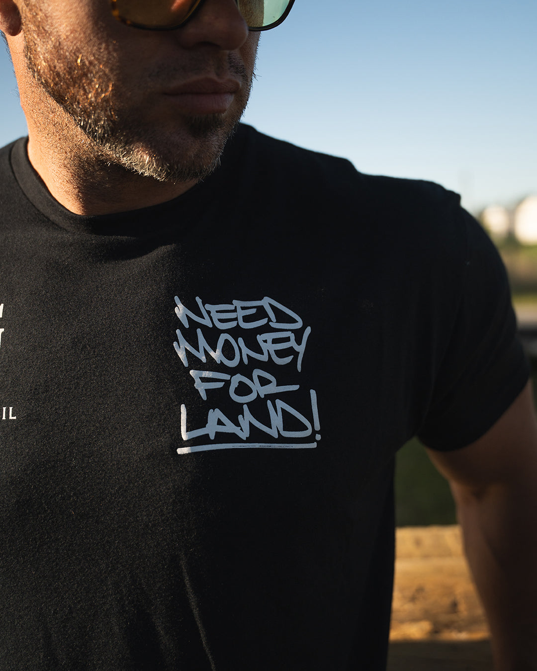 NEED MONEY FOR LAND Script Tee - Black Cotton Graphic T-Shirt for Streetwear & Urban Fashion | Casual Outfit Essential