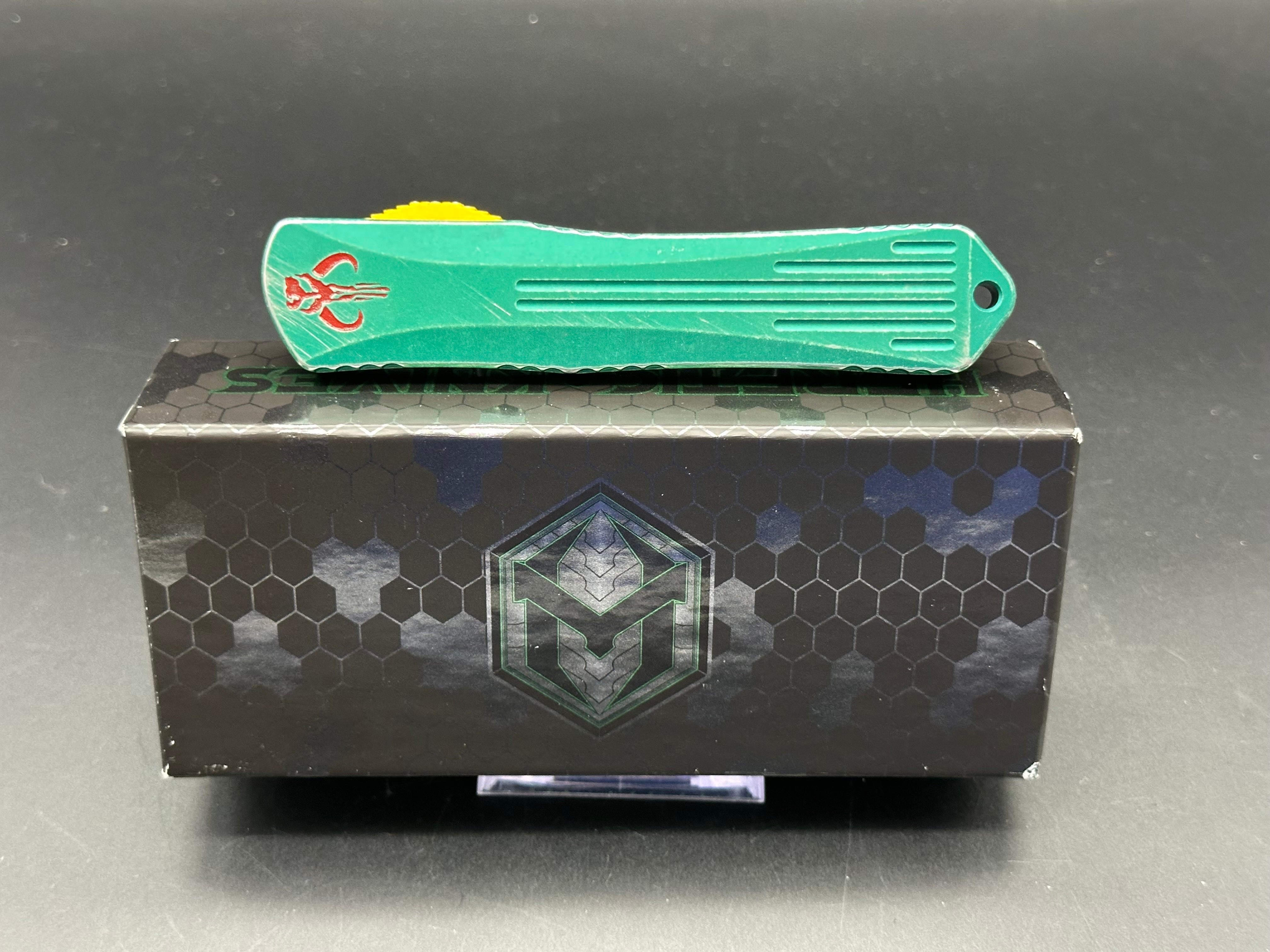 Heretic Manticore X Bounty Hunter Camo Carbon Handle OTF Knife - Black MagnaCut Serrated Tanto Blade for Tactical, Outdoor & EDC Use