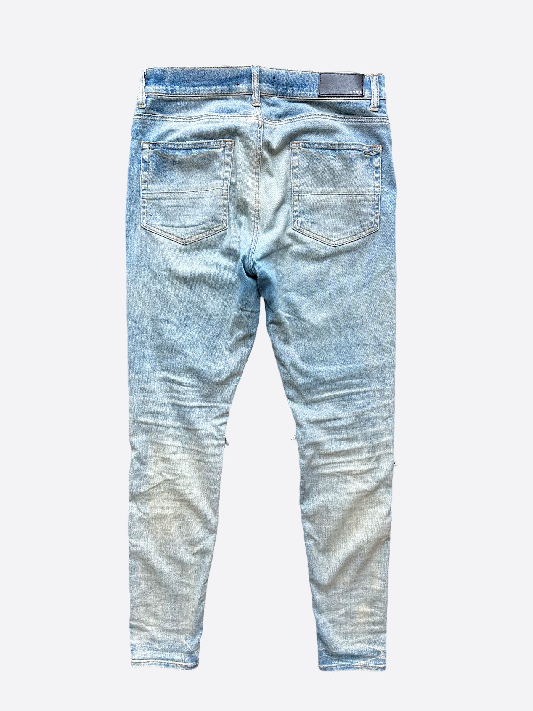 Amiri Blue Distressed Jeans with Multicolor Patches - Stylish Ripped Denim Pants for Men | Perfect for Casual Outfits, Streetwear & Night Out Looks