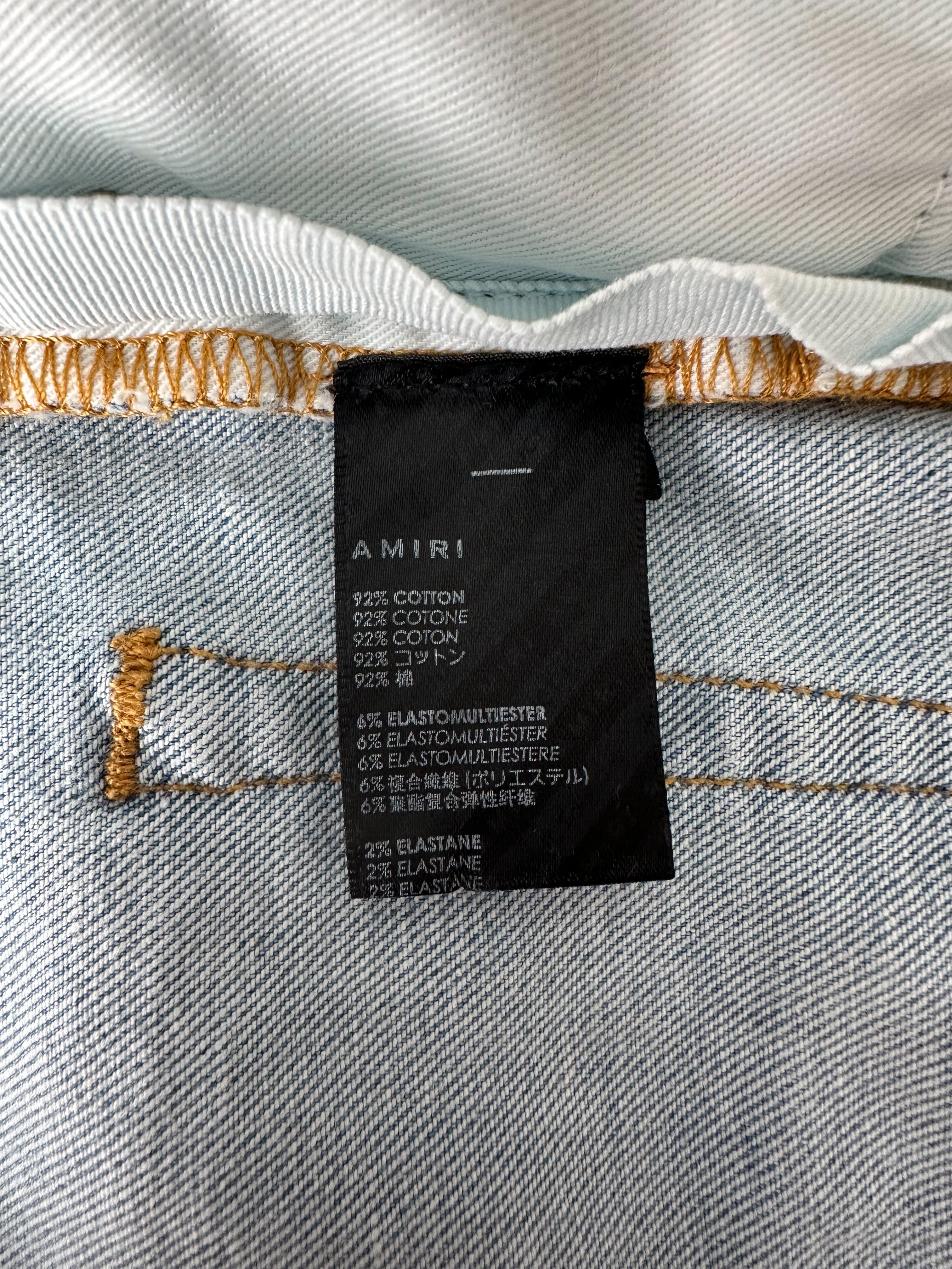Amiri Blue MA Logo Stencil Jeans - Distressed Denim Pants for Men | Streetwear Fashion | Perfect for Casual Outfits & Night Out