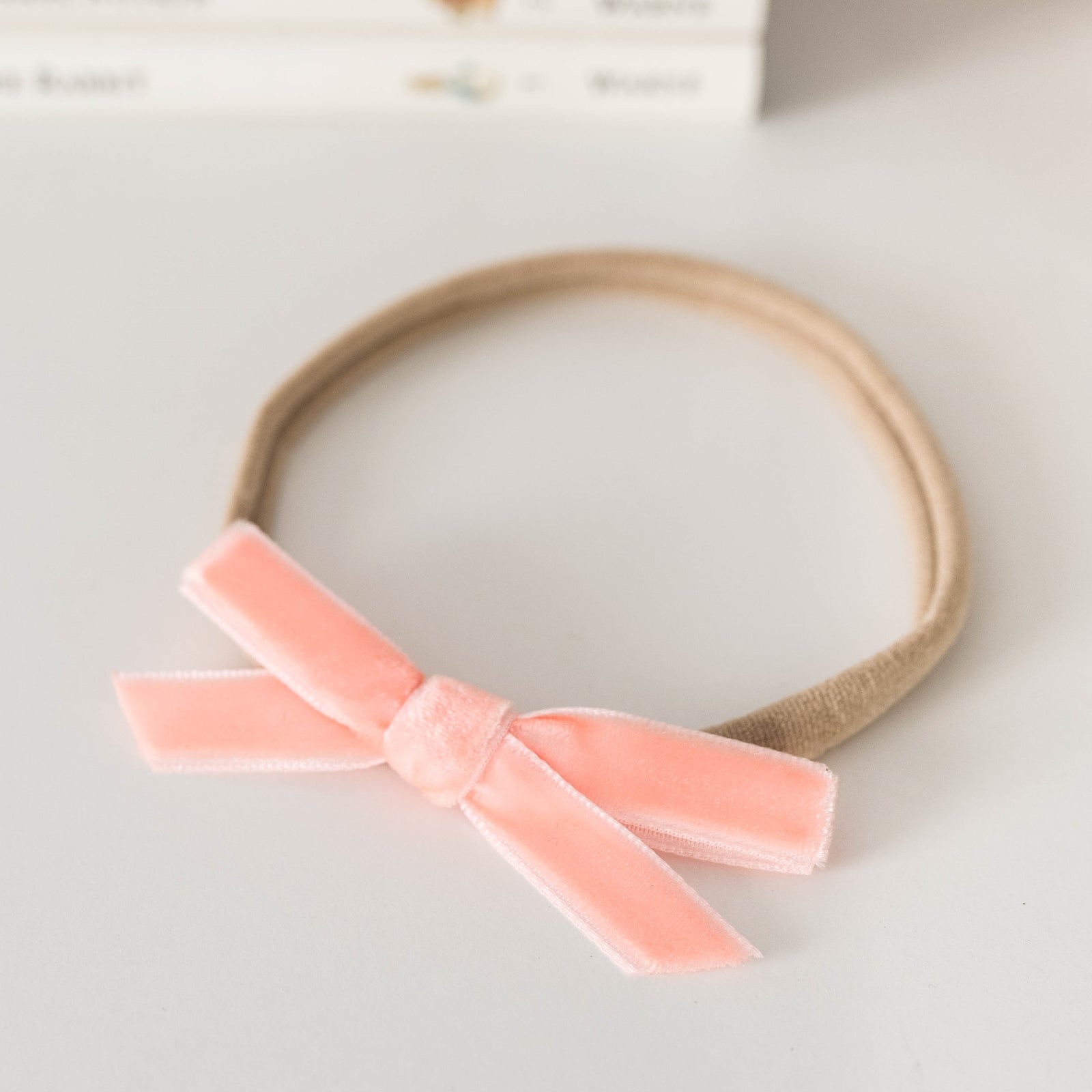 Snuggle Hunny Velvet Bow Stretchy Headband for Women - Soft Coral Hair Accessory for Workouts, Yoga, and Everyday Fashion