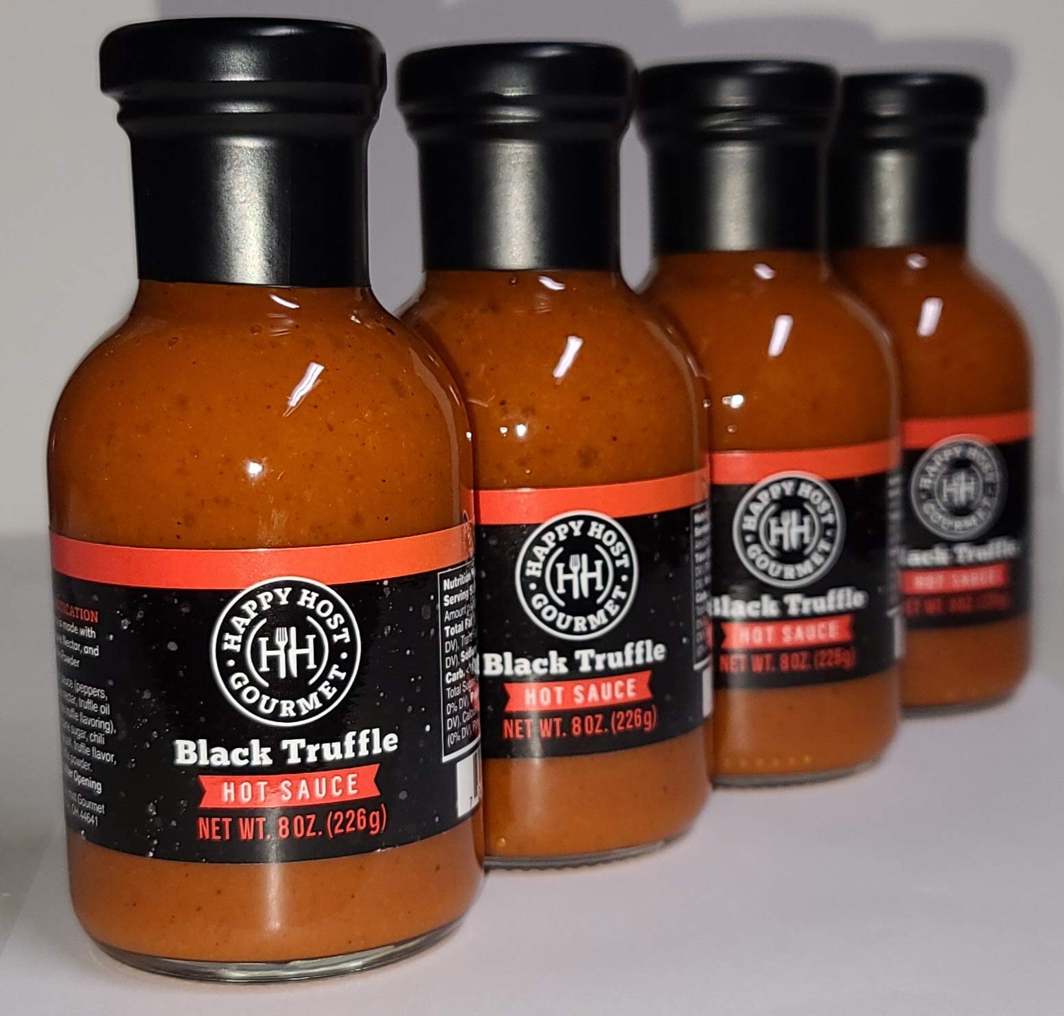 Happy Host Gourmet Black Truffle Hot Sauce 4 Pack - Premium Spicy Sauce with Ripe Chili Peppers, Agave Nectar & Black Truffle Oil - 25% Larger Bottle - Perfect for Burgers, Pizzas, Tacos & Gourmet Cooking