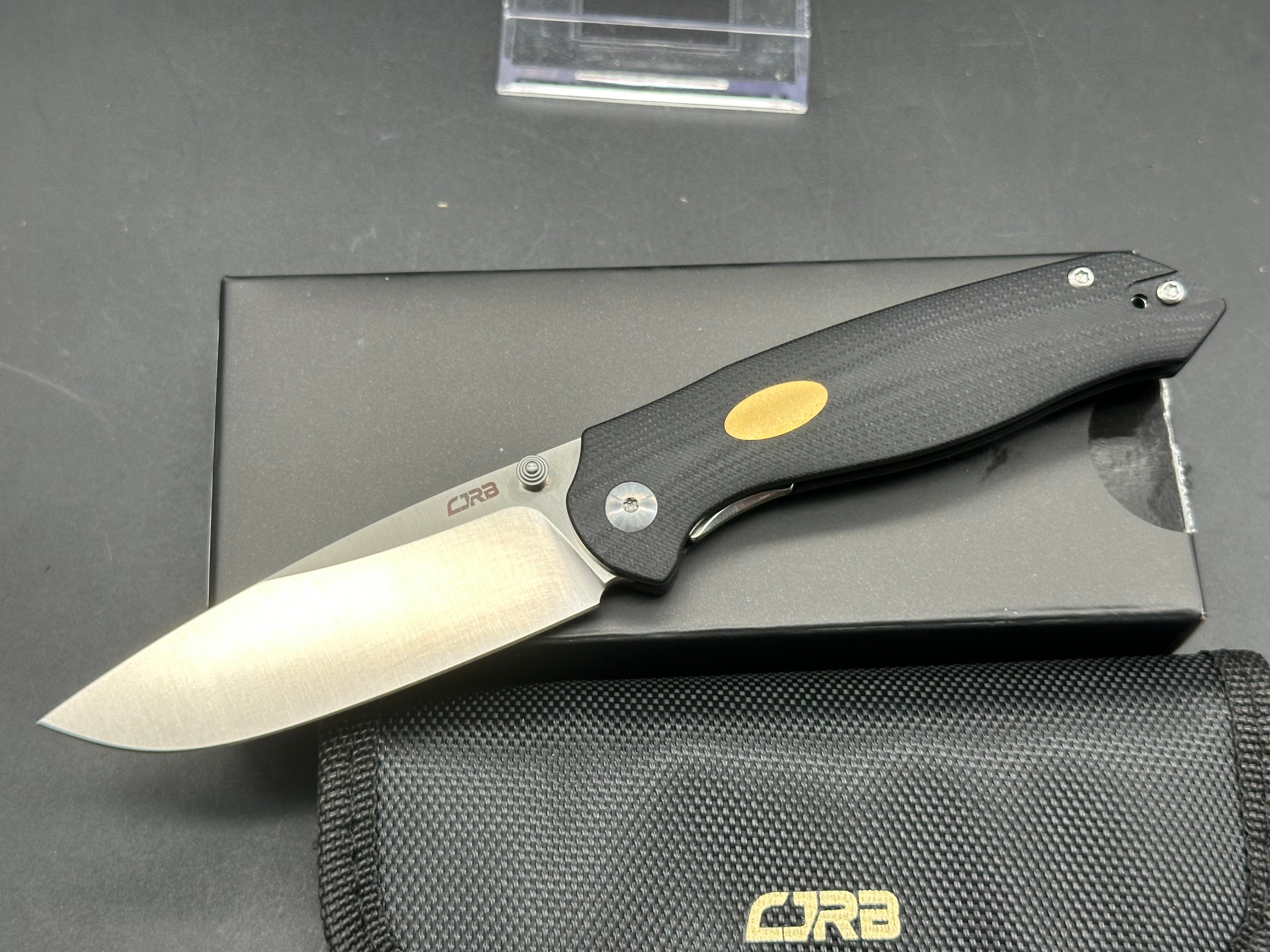 CJRB AES Folding Knife - Black G10 & Brass Handle, AR-RPM9 Steel, Drop Point Plain Edge, Sand Polish Finish - EDC, Camping, Outdoor Survival