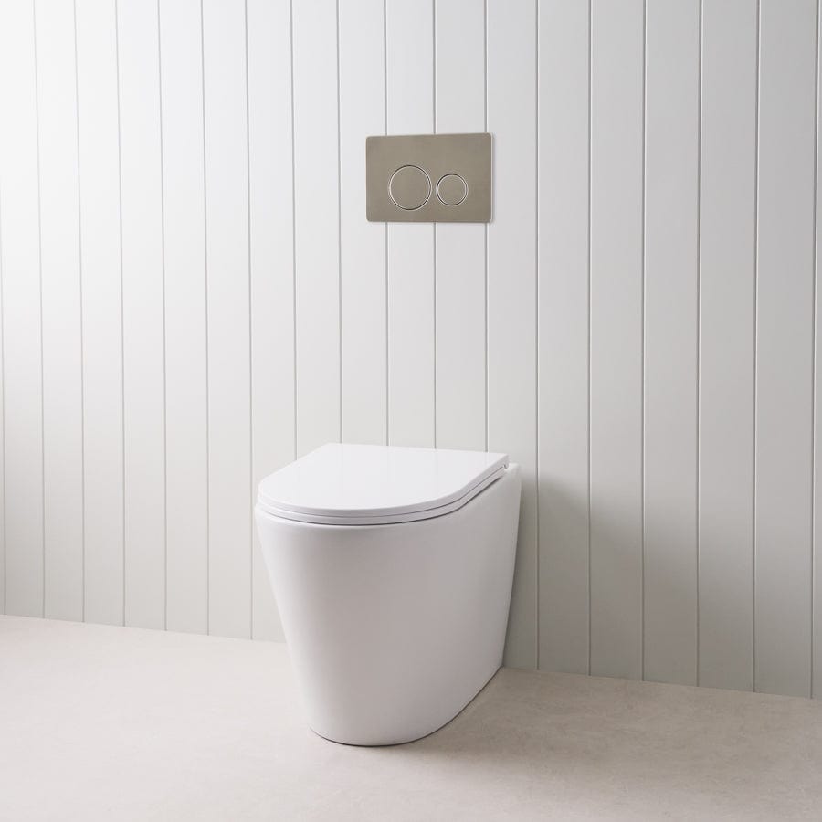 Angled In-Wall Toilet with Round Stainless Steel Buttons - Modern Space-Saving Bathroom Solution for Small Homes and Apartments