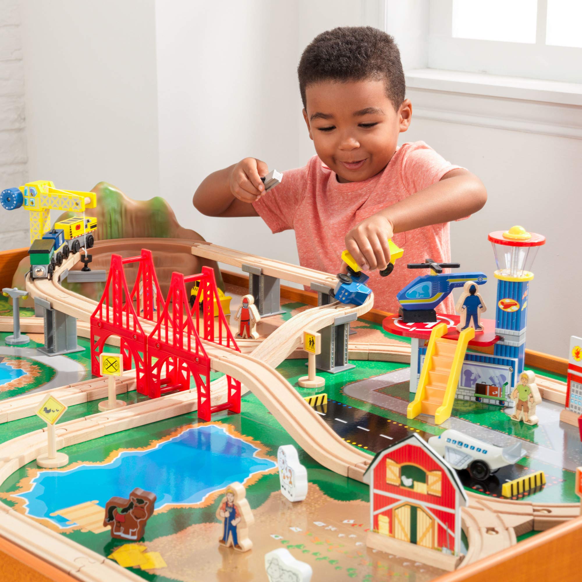 KidKraft Ride Around Town Wooden Train Set with Table - 100-Piece Playset Includes Helicopter, Airplane & Farm Accessories - Storage Bins & Major Brand Compatibility - Perfect for Preschool Playrooms & Toddler Birthday Gifts (Honey Finish)