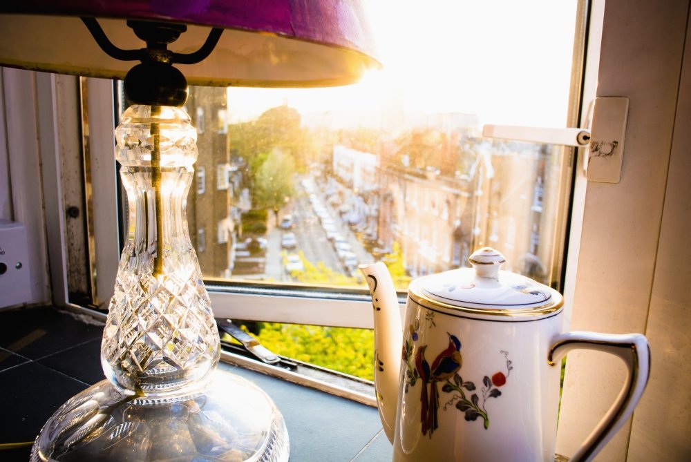 Vintage Teapot and Lamp on Windowsill in Afternoon Sun - Baron's Court West London England Poster Print (38 x 24) - Perfect for Kitchen Decor, Tea Lover Gifts & British Theme Home Decoration