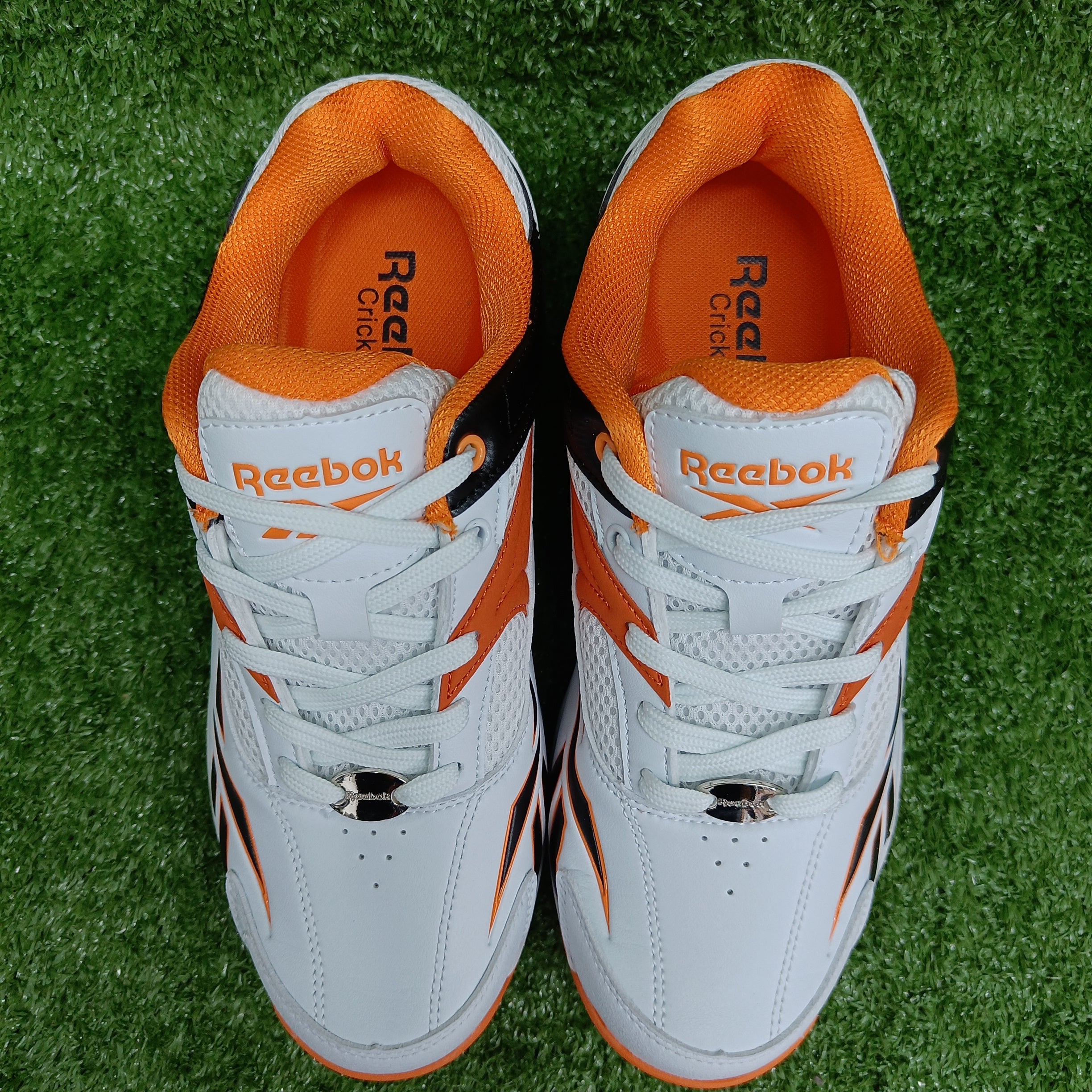 Reebok Not Out Syndicate Cricket Shoes - White, Black & Shocking Orange - Metal Spike Cleats for Enhanced Grip & Performance on the Pitch | Perfect for Professional & Amateur Cricket Matches