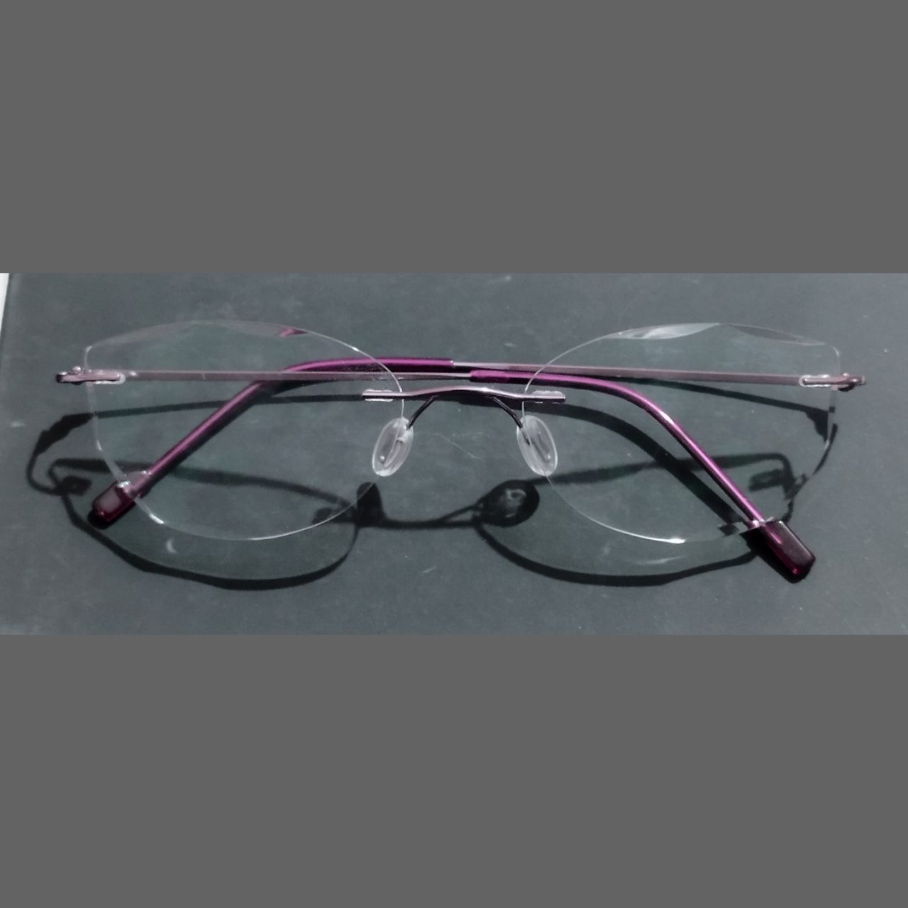 Stylish Purple Cat Eye Rimless Glasses with Diamond Cut Edges - Trendy Women's Fashion Eyewear for Work, Party & Everyday Wear