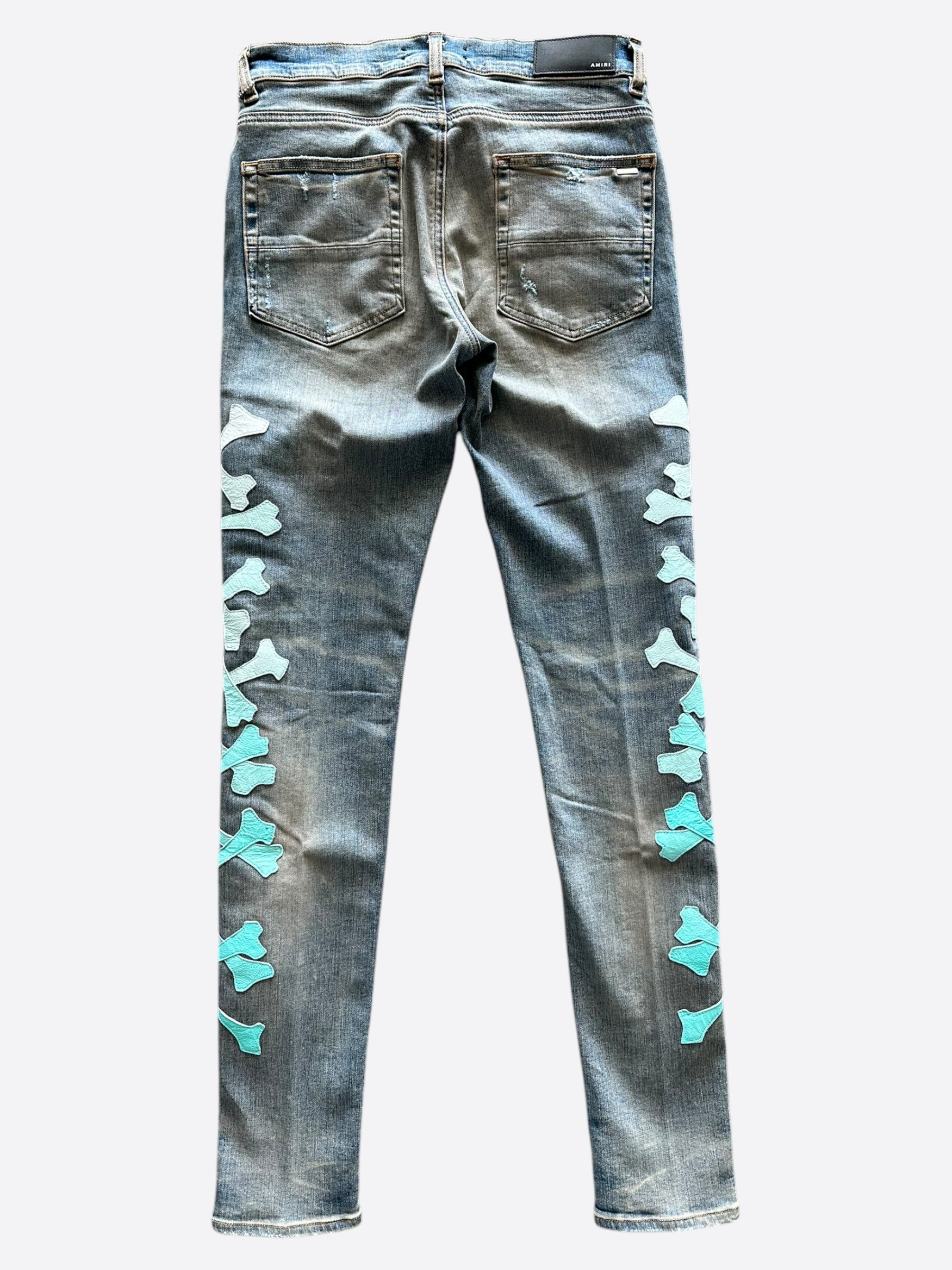 Amiri Blue & Turquoise Gradient Bones Applique Distressed Jeans for Men - Vintage Washed Denim Pants with Unique Embellishments, Perfect for Streetwear & Casual Outfits