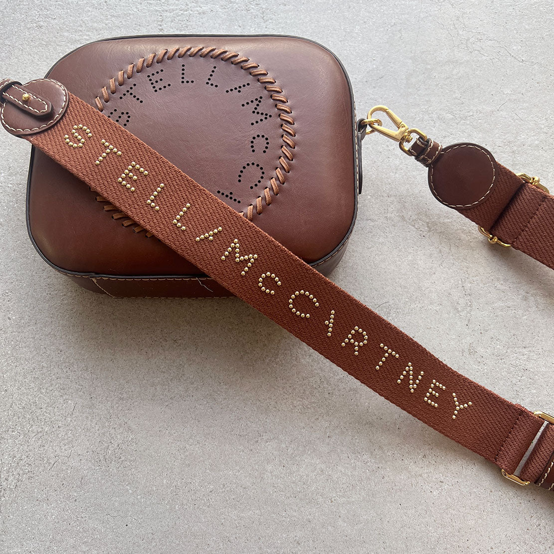 Stella Logo Camera Bag with Whip/Stud Strap in Cognac - Stylish Crossbody Bag for Photographers & Travel Enthusiasts | Perfect for Everyday Use, Travel & Photography Adventures
