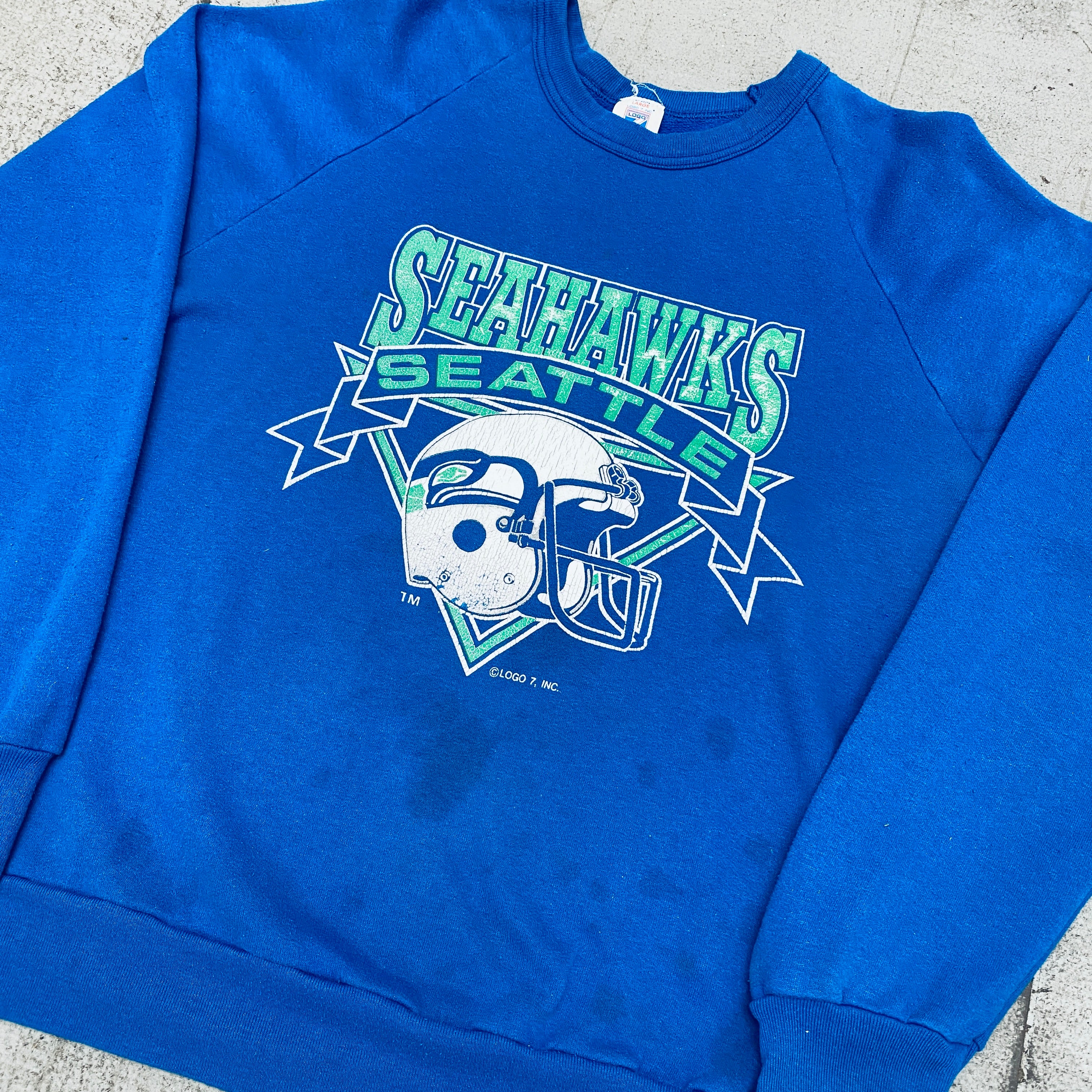 Seattle Seahawks Vintage 1990s Logo 7 Graphic Spellout Sweatshirt (Small) - Perfect for Game Day, Sports Fans & Retro Fashion Enthusiasts