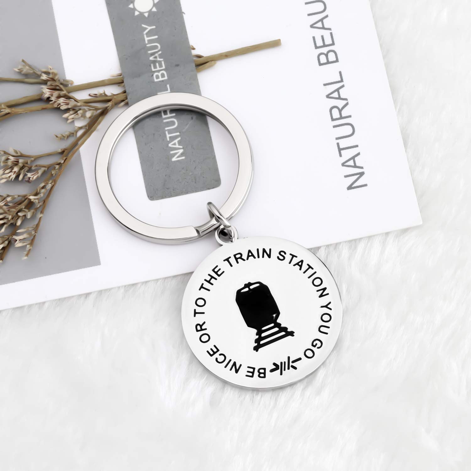 Funny TV Show Inspired Keychain - 'Be Nice Or To The Train Station You Go' Quote - Perfect Gift for TV Show Fans & Pop Culture Enthusiasts - Great for Keyrings, Backpacks, and Fan Collections