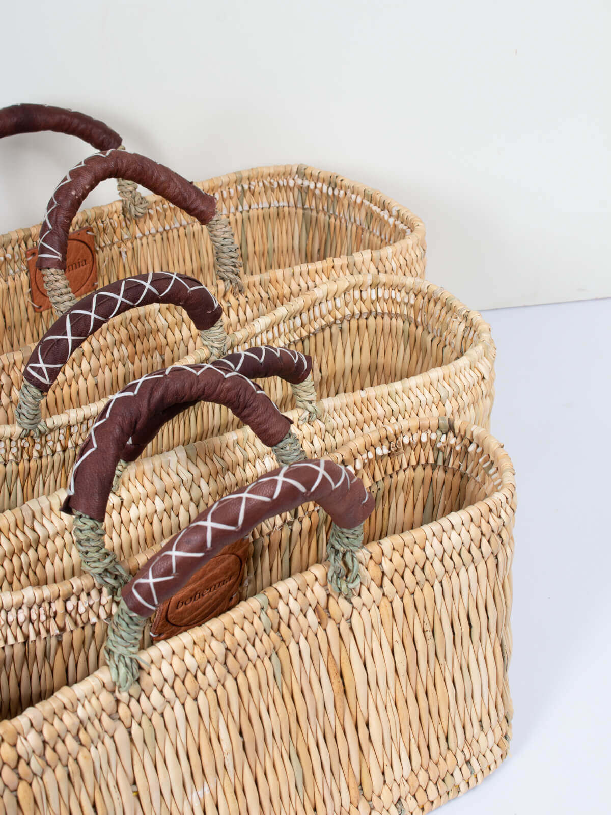 Handwoven Reed Basket with Genuine Leather Handles - Natural Woven Storage Bin for Home Decor, Laundry, or Picnic Basket - Perfect for Organizing Blankets, Toys, and More