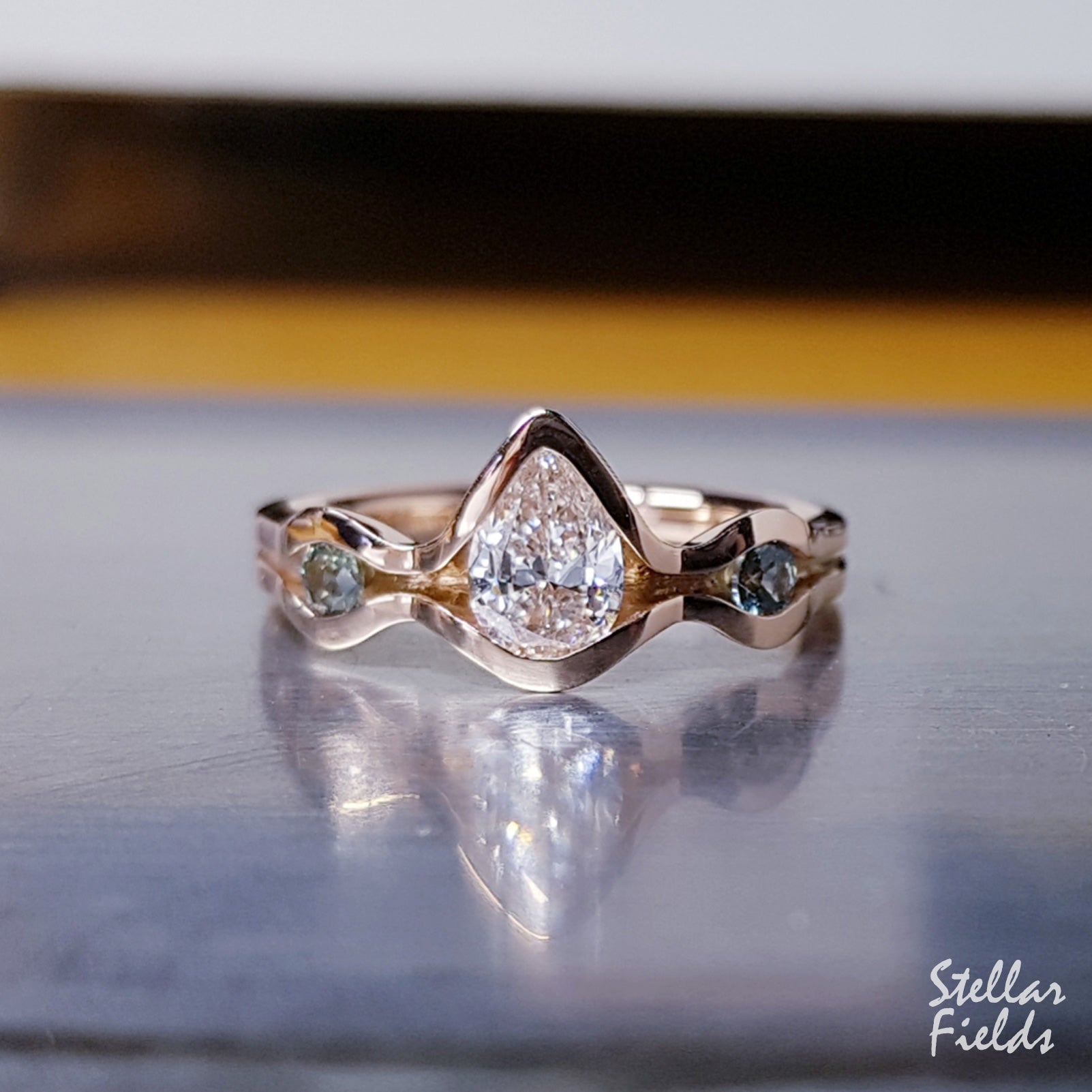 Three Stone Pear Diamond Modern Engagement Ring with Teal Montana Sapphire Accents - Elegant Wedding Jewelry for Proposals, Anniversaries & Special Occasions