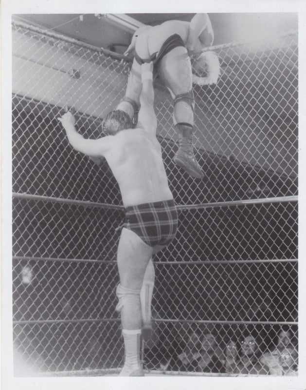 Vintage 1980s Portland Wrestling Photo - Rowdy Roddy Piper vs. Playboy Buddy Rose Cage Match | Rare Collectible Wrestling Memorabilia for Fans & Sports Decor
