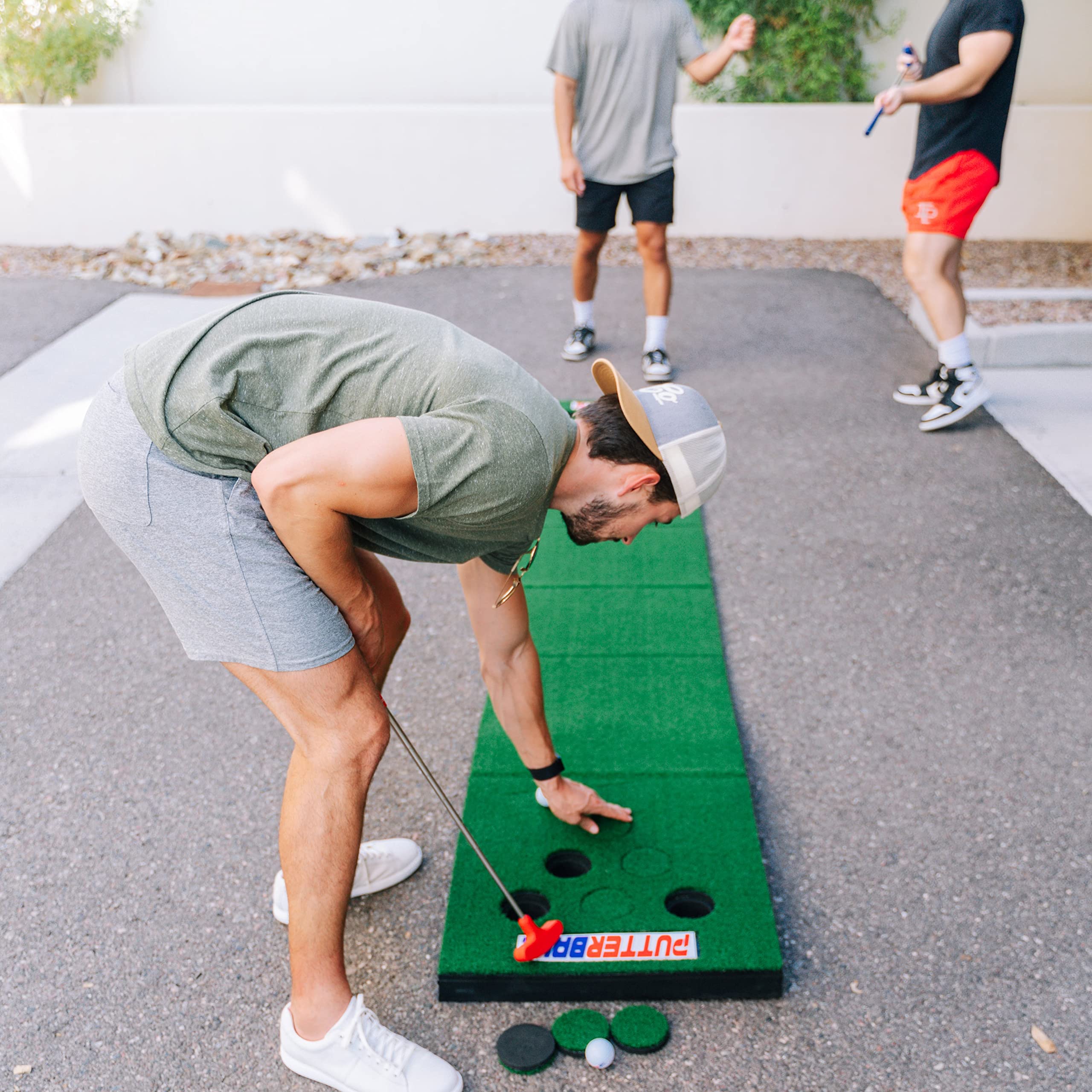 PutterBall Original Golf Pong Game Set - 2 Putters, 2 Balls & Hole Covers - Backyard Putting Green Mat for Indoor & Outdoor Fun - Perfect Party Game for Home, Office, Beach - Great Gift for Family & Friends - Ideal for BBQs, Tailgating & Backyard Parties