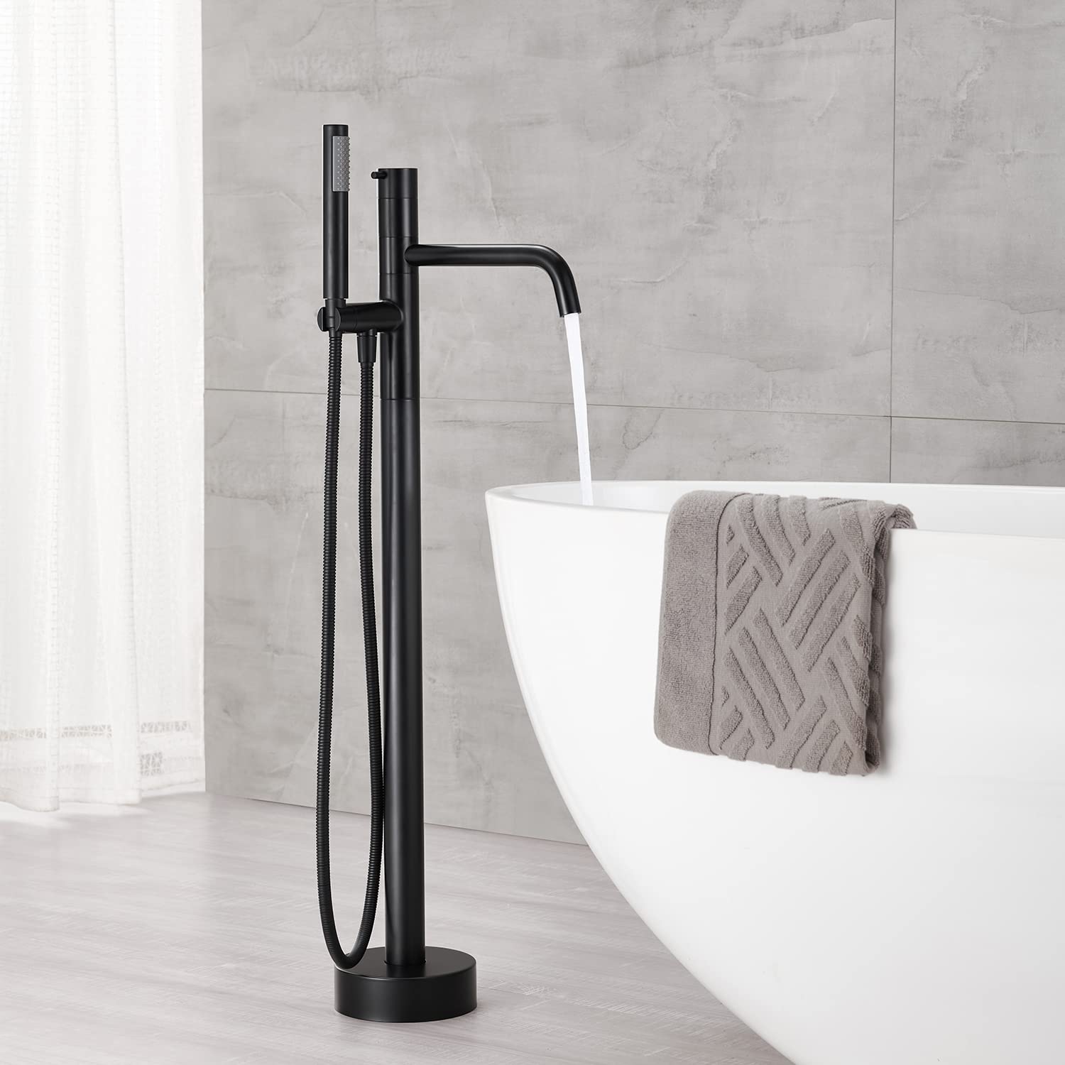 Freestanding Bathtub Faucet - Black Floor Mount Brass Single Handle Tub Filler with Hand Shower for Modern Bathroom | Perfect for Spa-Like Relaxation & Luxury Bathing Experience