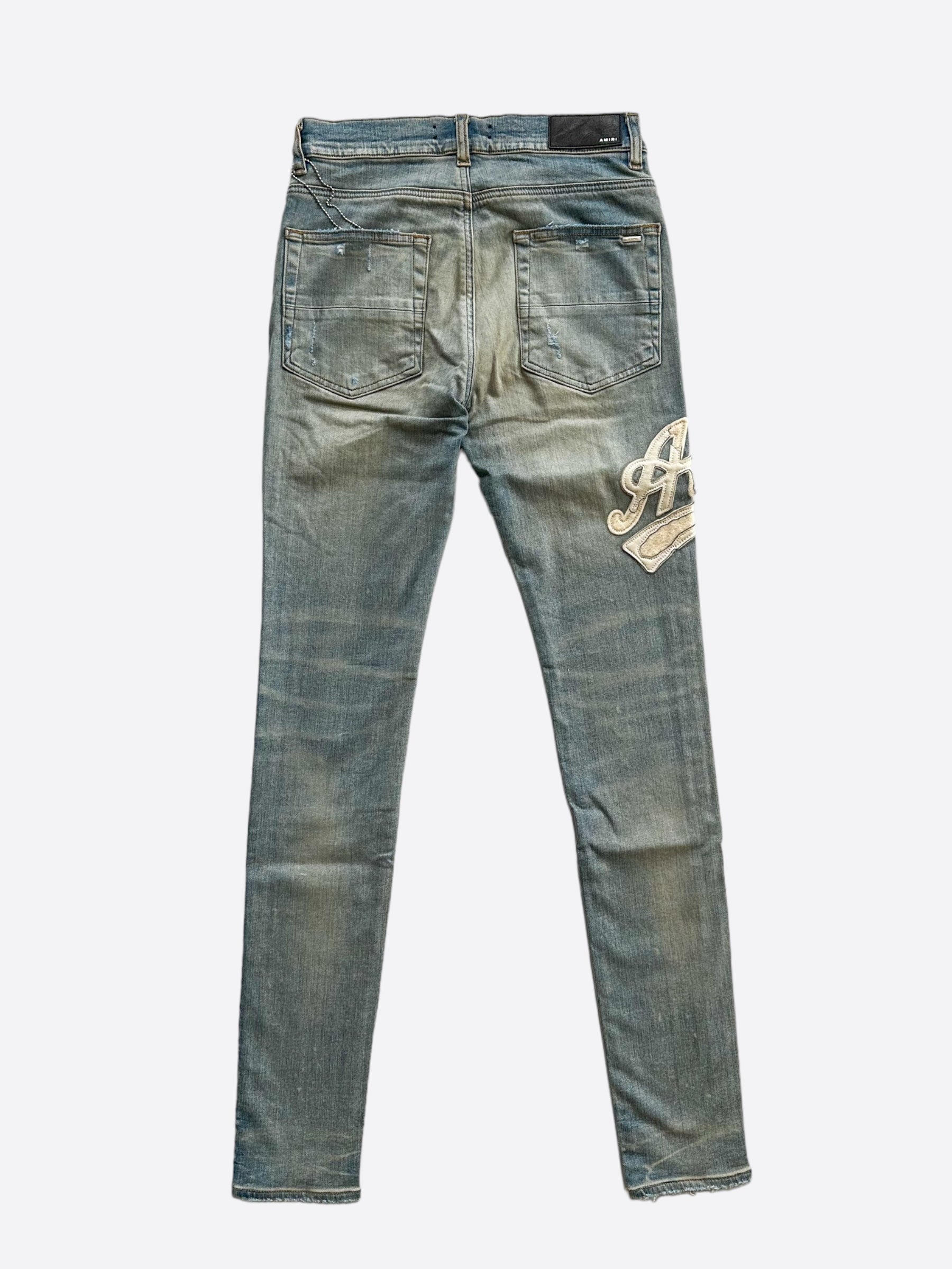 Amiri Clay Indigo Varsity Applique Logo Jeans for Men - Premium Distressed Denim Pants with Embroidered Patch | Streetwear Fashion & Casual Outfit