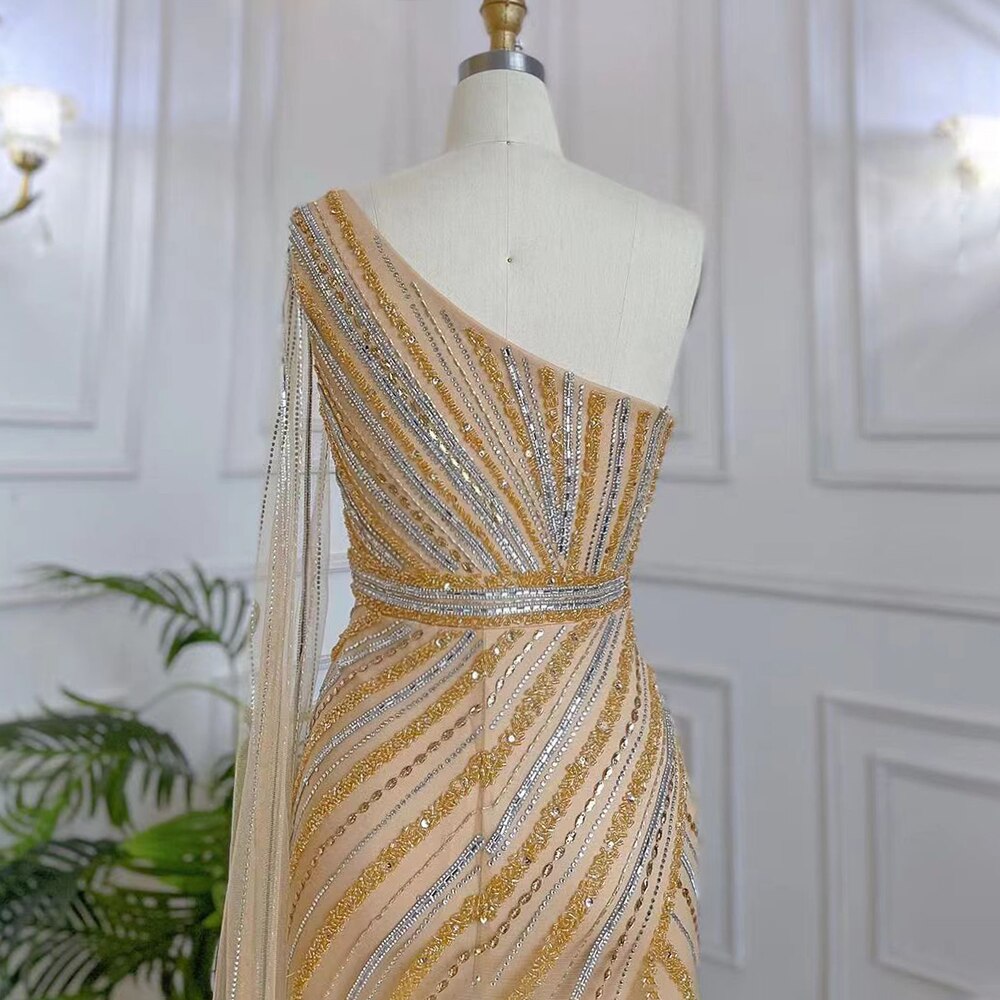 Elegant Gold Mermaid Evening Gown with One Shoulder Cape Sleeve & High Slit - Luxury Beaded Prom Dress for Women - Perfect for Red Carpet Events, Galas & Formal Occasions - Serene Hill Collection LA71902