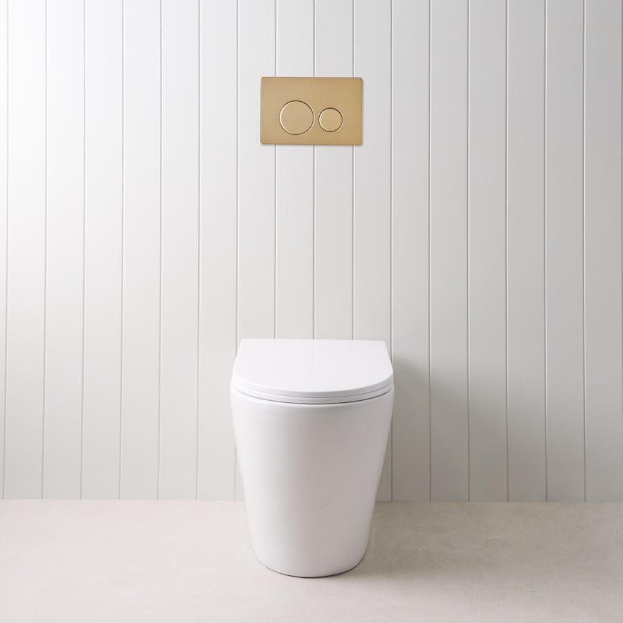 Angled In-Wall Toilet with Round Warm Brushed Nickel Buttons - Modern Space-Saving Bathroom Solution for Small Homes and Apartments