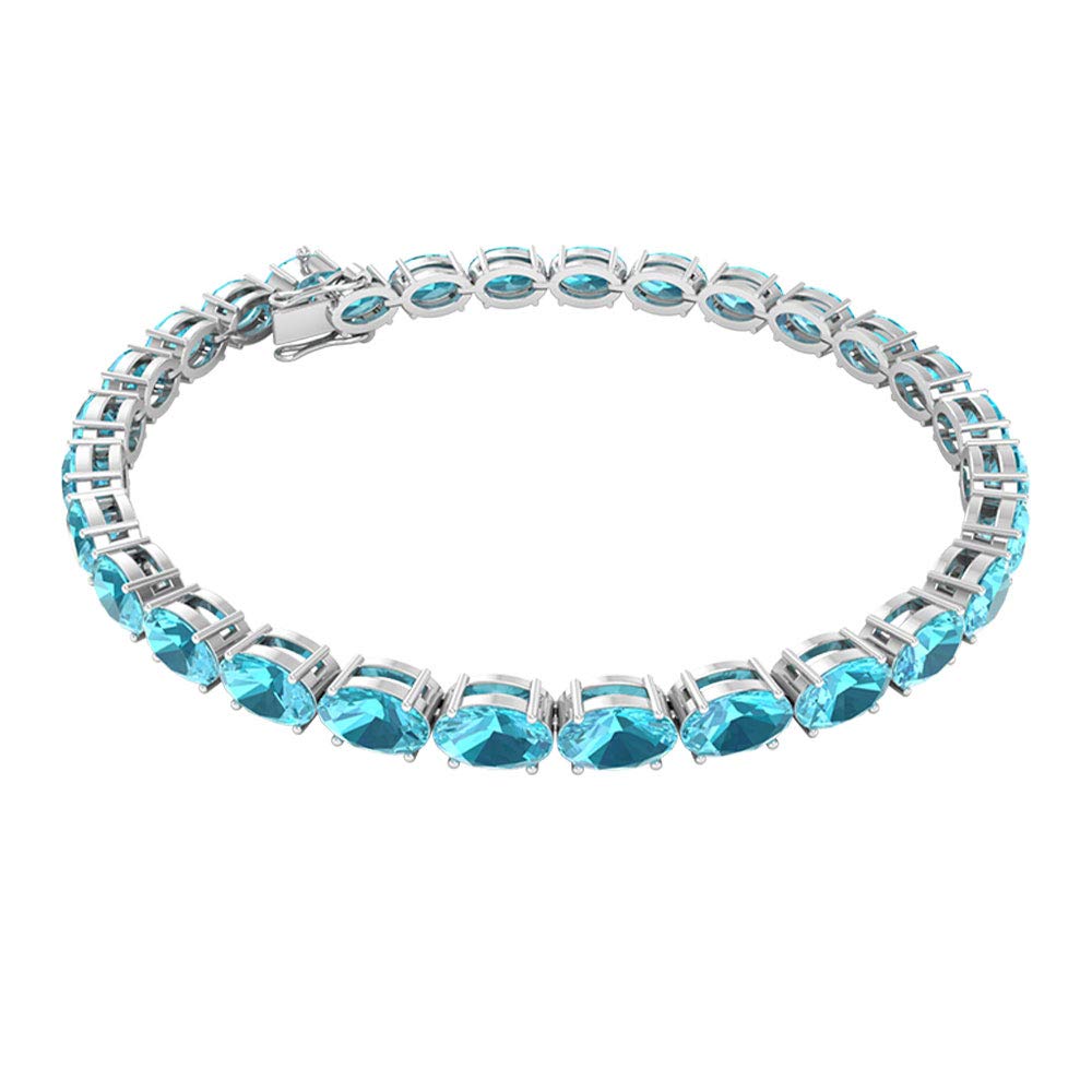 6x4mm Blue Topaz Tennis Bracelet - 16.5 CT Oval Swiss Gemstone Charm Bracelet in 14K White Gold (7 Inches) | Perfect for Weddings, Anniversaries & Special Occasions