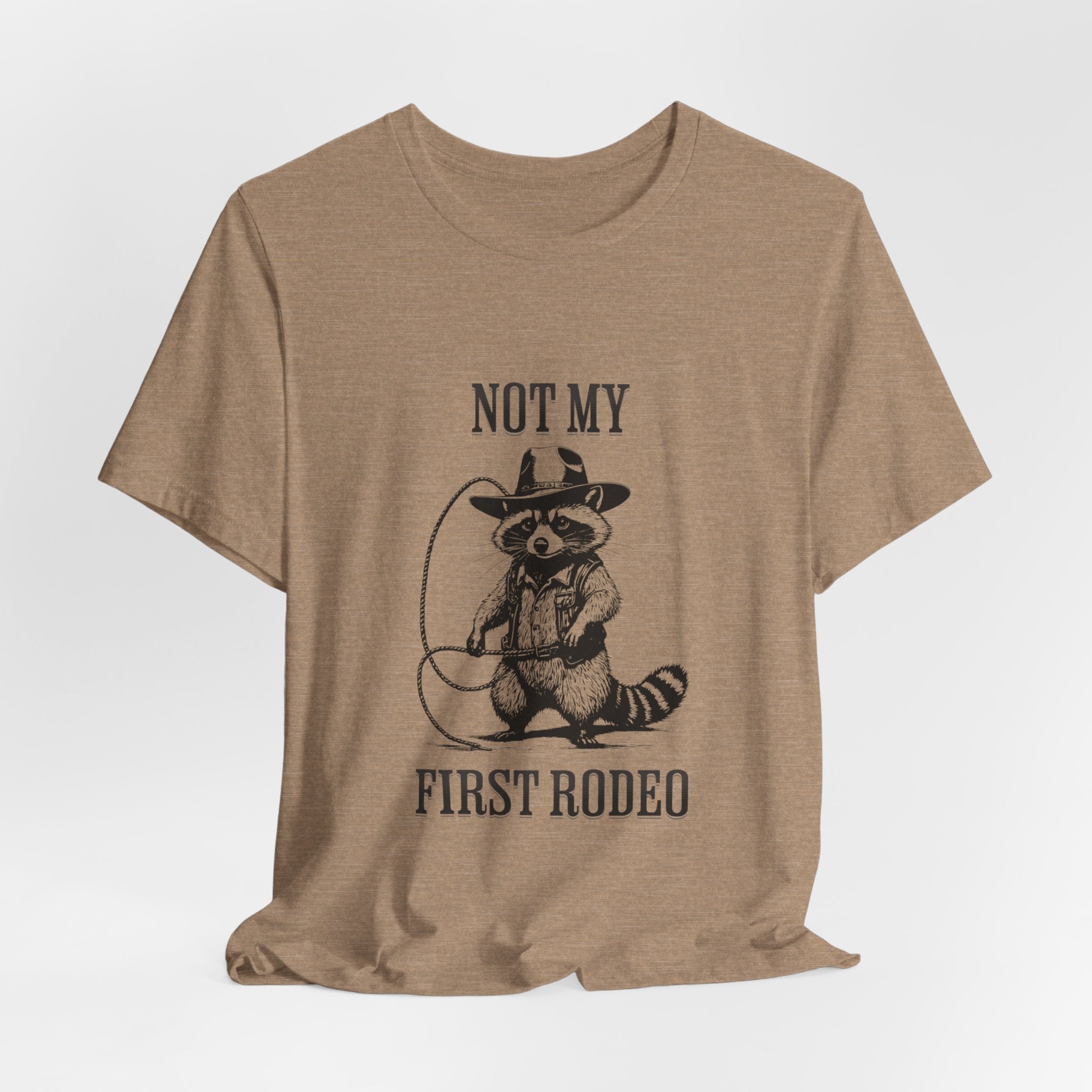 Funny Western Graphic Cotton Tee - Not My First Rodeo Cowboy Raccoon Shirt | Cute Quirky Country Style T-Shirt for Rodeo Fans & Animal Lovers | Perfect for Rodeo Events, Country Concerts & Casual Wear