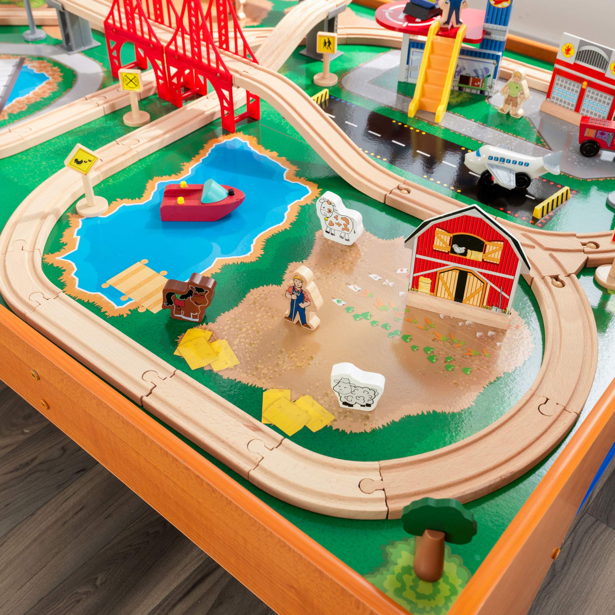 KidKraft Ride Around Town Wooden Train Set with Table - 100-Piece Playset Includes Helicopter, Airplane & Farm Accessories - Storage Bins & Major Brand Compatibility - Perfect for Preschool Playrooms & Toddler Birthday Gifts (Honey Finish)
