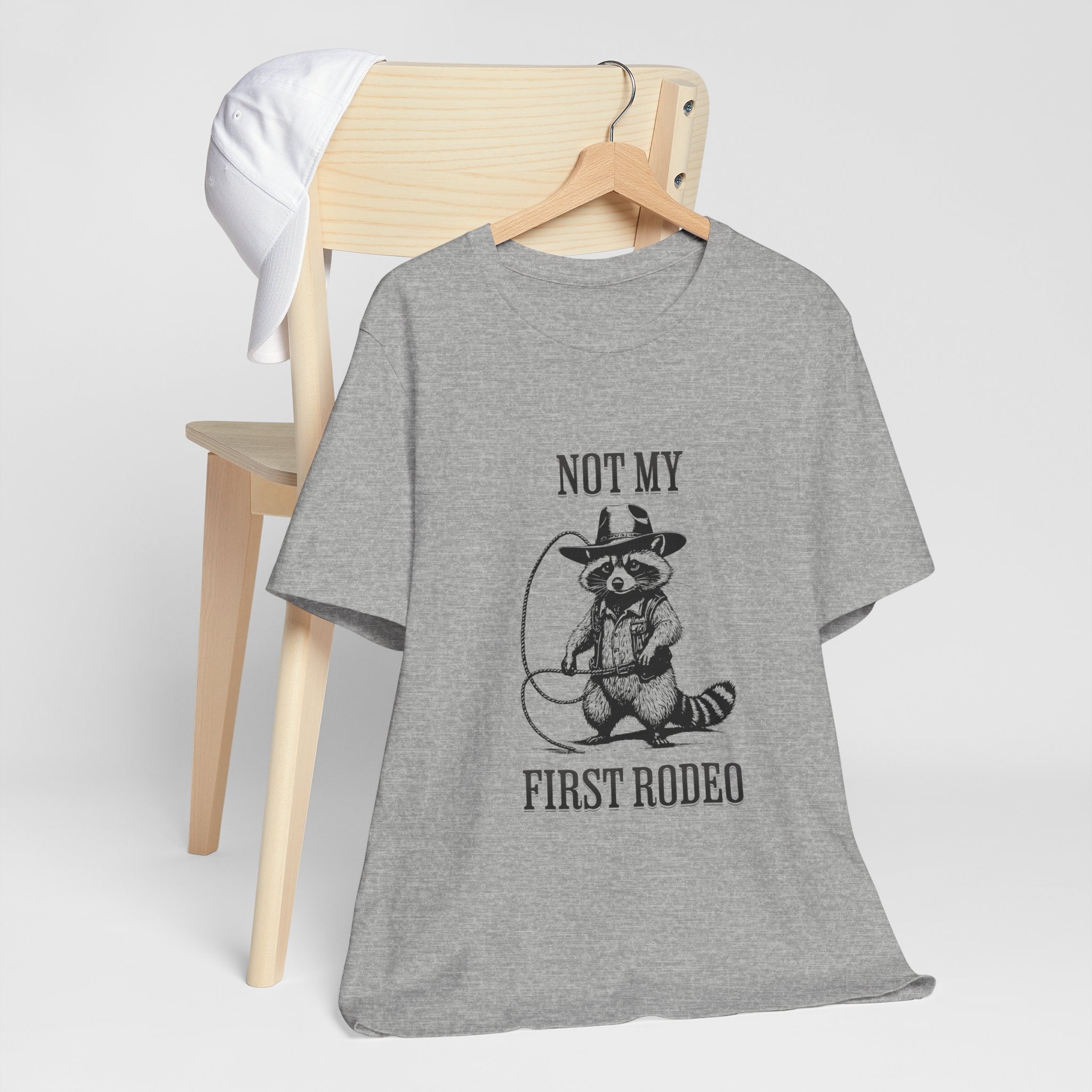 Funny Western Graphic Cotton Tee - Not My First Rodeo Cowboy Raccoon Shirt | Cute Quirky Country Style T-Shirt for Rodeo Fans & Animal Lovers | Perfect for Rodeo Events, Country Concerts & Casual Wear