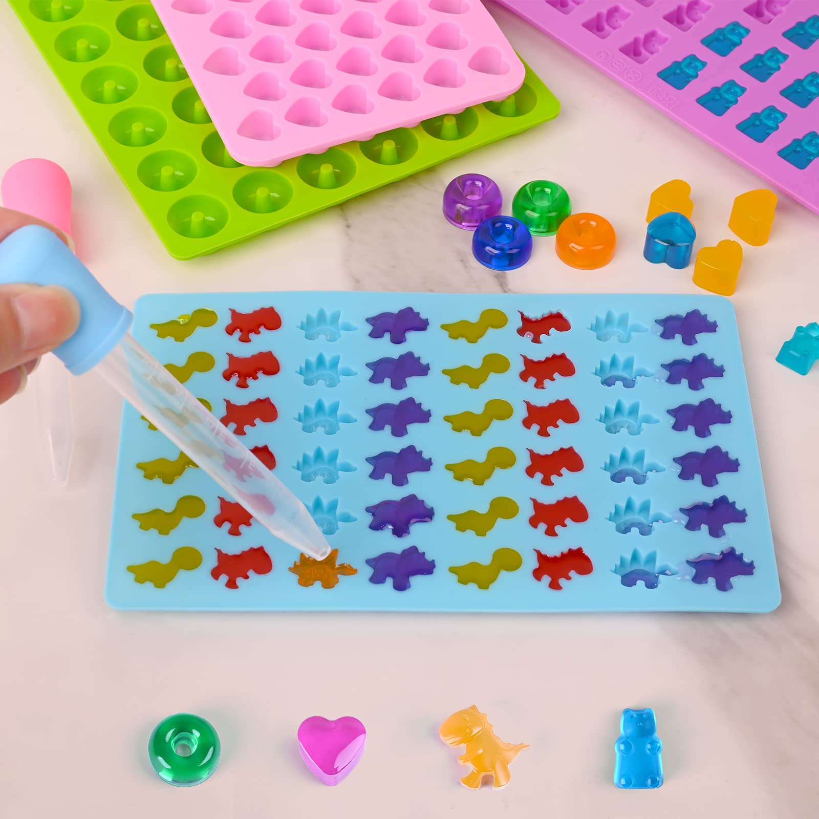Sakolla 4-Pack Mini Silicone Gummy Candy Molds with 2 Droppers - Dinosaur, Bear, Heart & Donut Shapes for Chocolate, Candies & DIY Treats - Perfect for Kids' Birthday Parties, Baking Decorations & Homemade Snacks