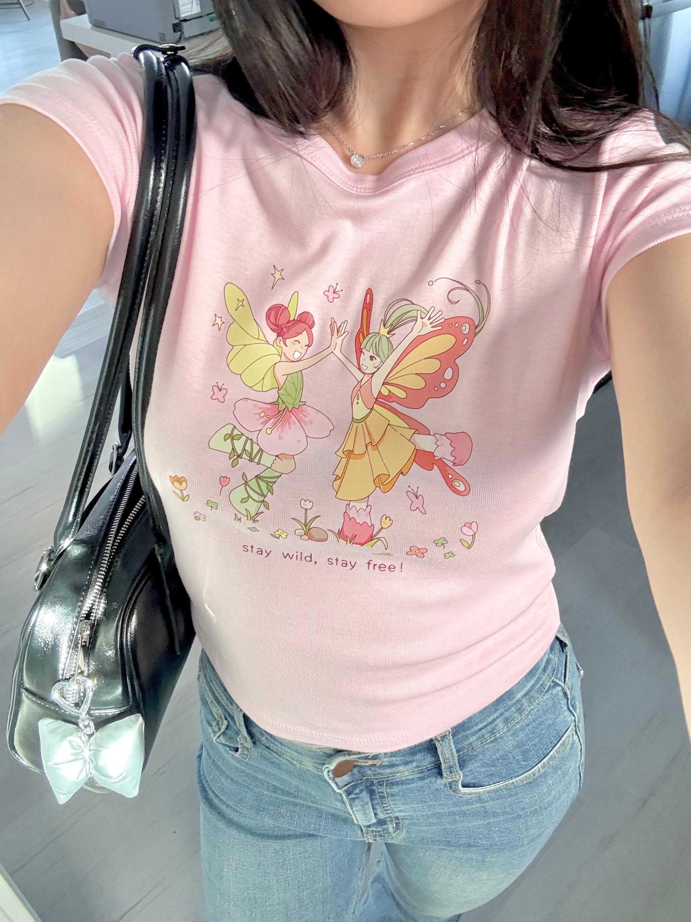 Dancing Fairies Baby Tee - Fairycore Aesthetic Pastel Pink Graphic T-Shirt for Women | Cute Casual Outfit for Summer, Music Festivals & Fairy-Themed Parties