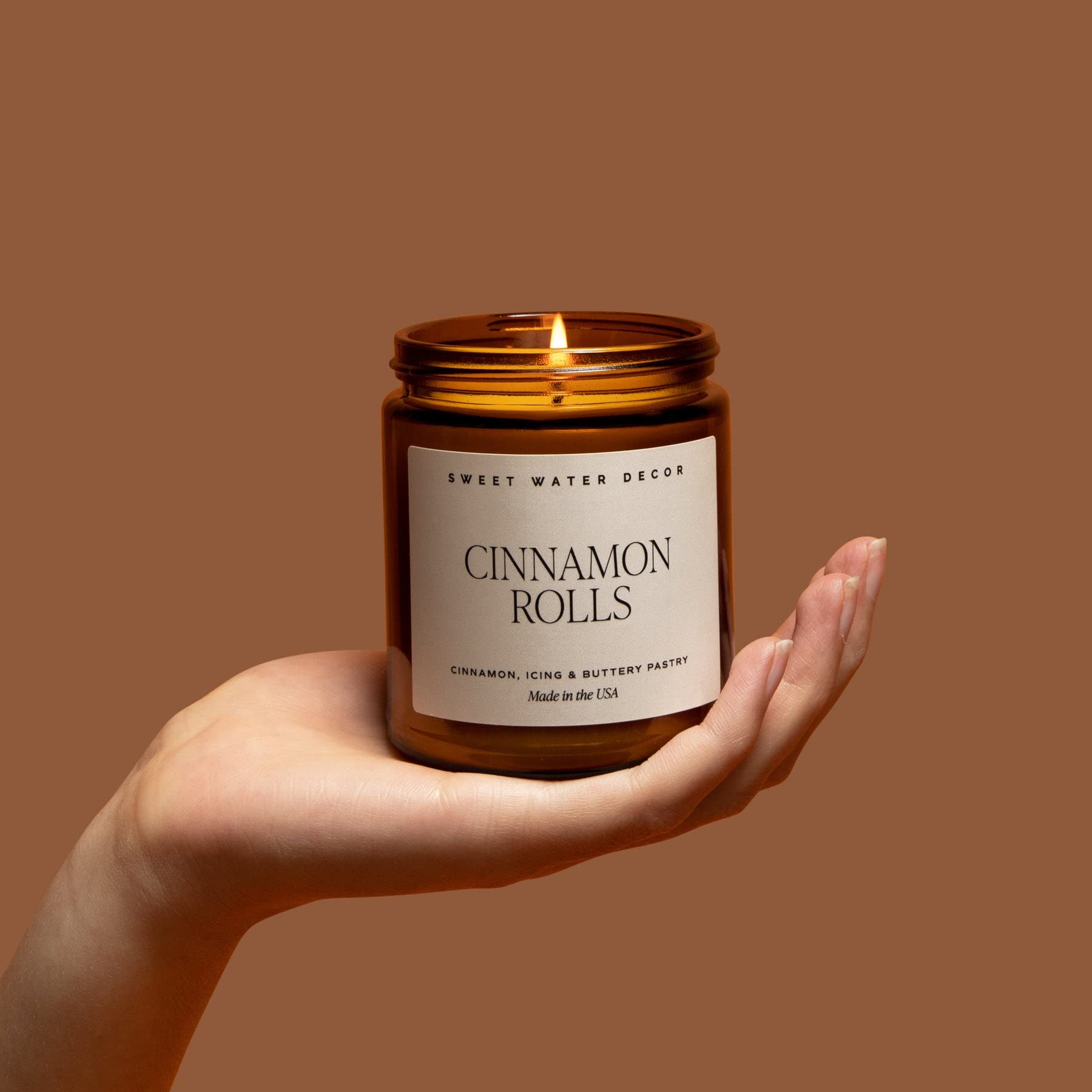 Sweet Water Decor Cinnamon Roll Scented Soy Candle - Christmas Holiday Home Fragrance with Cinnamon, Icing & Buttery Pastry Notes - 40 Hours Burn Time in 9Oz Amber Jar with Black Lid - Perfect for Cozy Winter Nights, Holiday Decor & Gift Giving