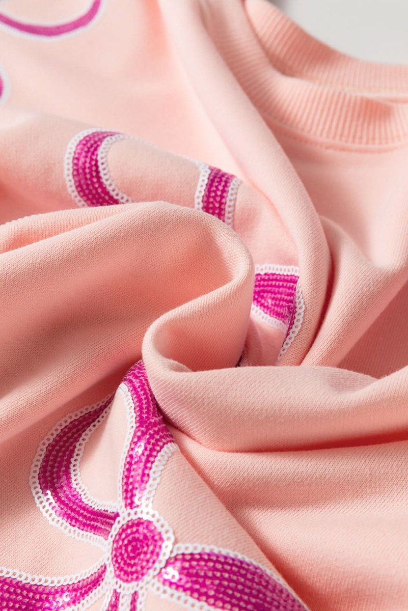 Stylish Apricot Pink Sequined Bowknot Drop Shoulder Oversized Sweatshirt for Women | Trendy Loose Fit Pullover | Perfect for Casual Outings, Parties & Date Nights