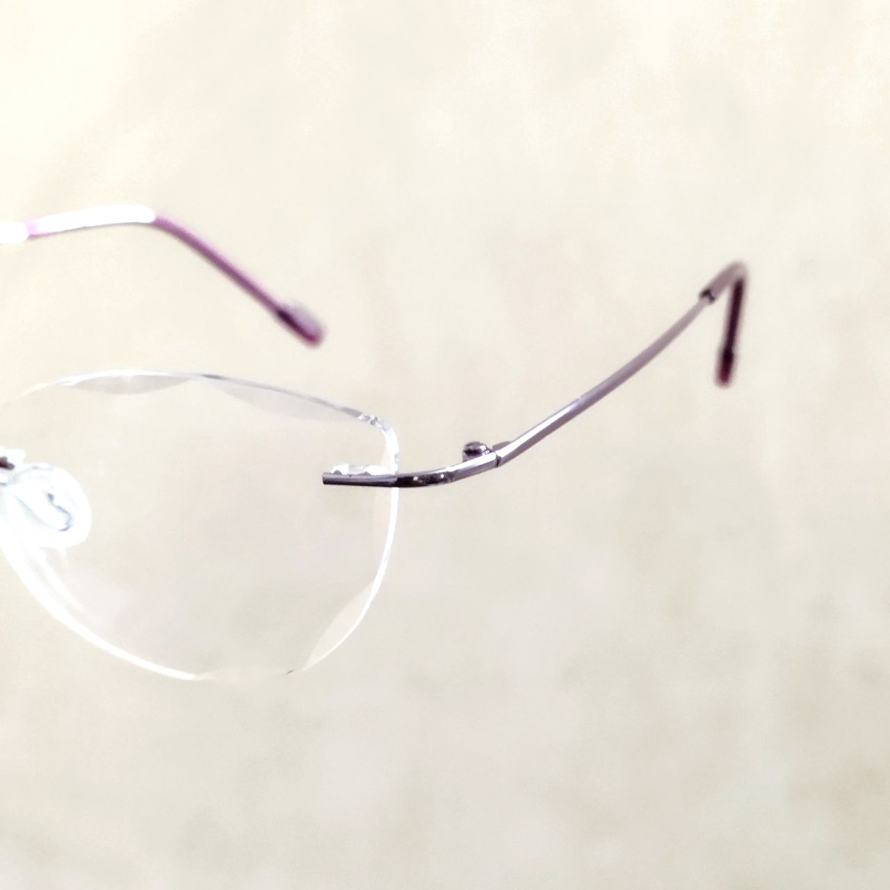 Stylish Purple Cat Eye Rimless Glasses with Diamond Cut Edges - Trendy Women's Fashion Eyewear for Work, Party & Everyday Wear