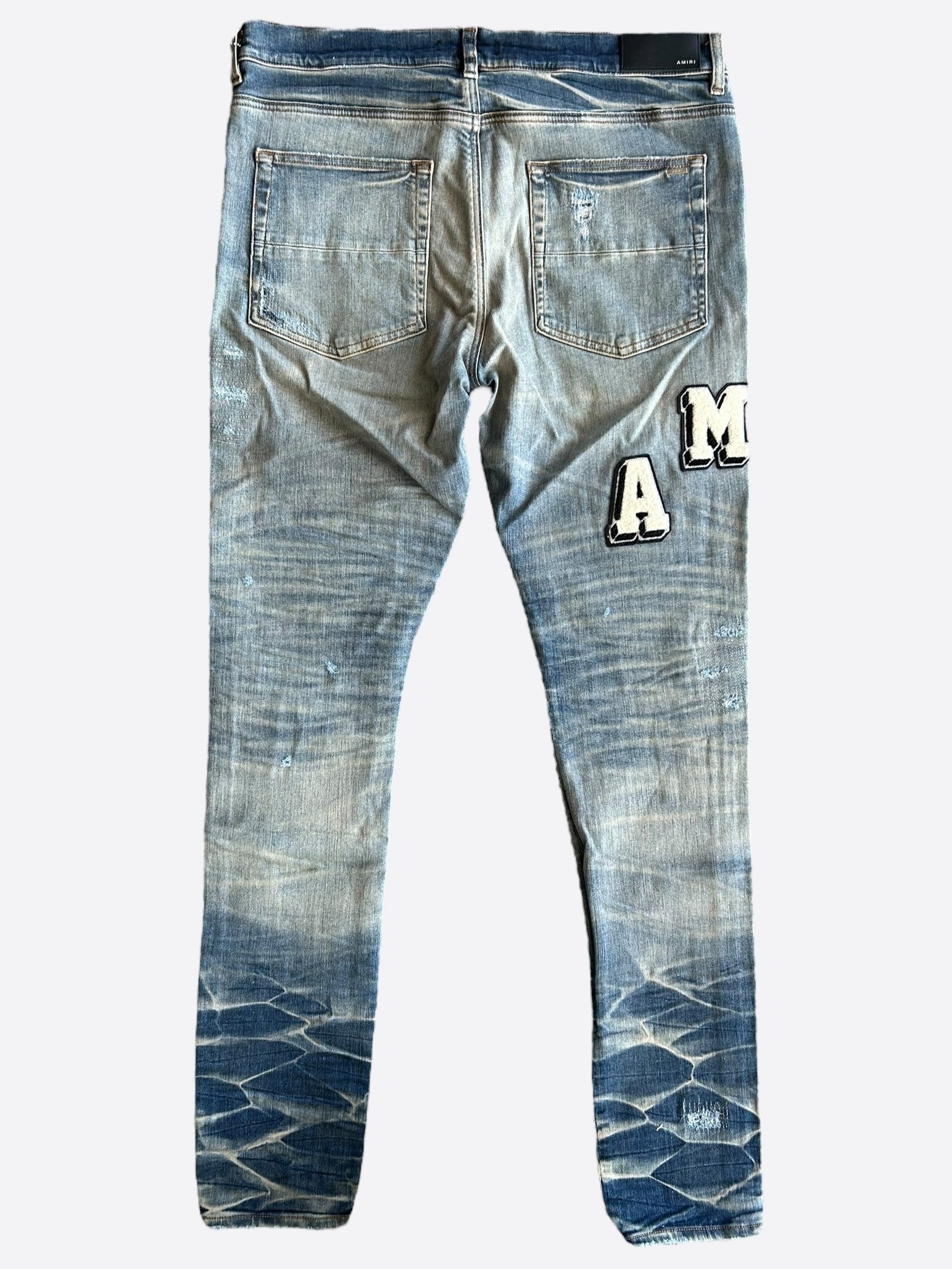 Amiri Vintage Indigo Varsity Applique Logo Jeans for Men - Distressed Denim Pants with Embroidered Patch - Perfect for Casual Wear & Street Style Outfits
