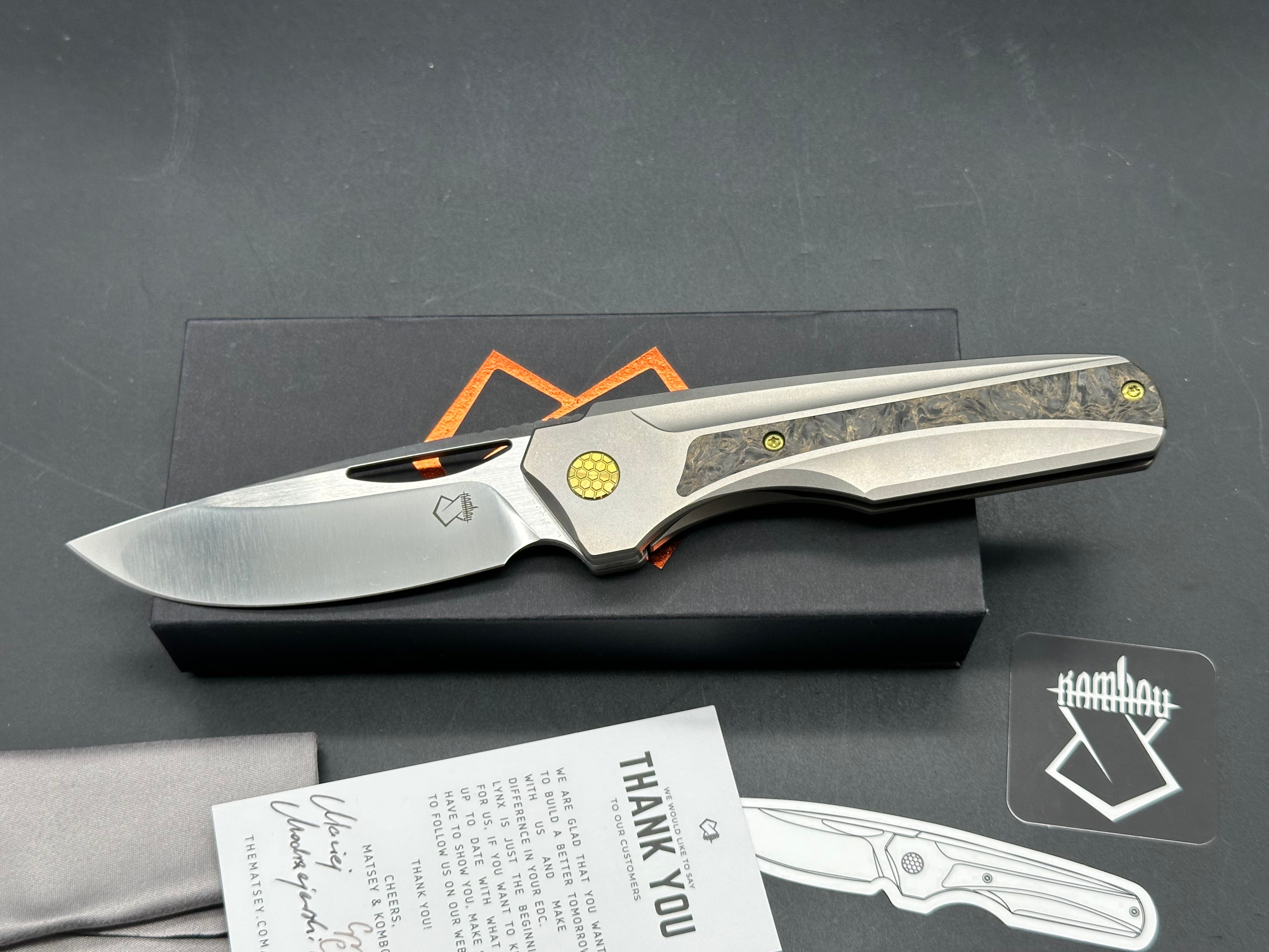 Premium Lynx Grey Titanium Handle Folding Knife with Gold Marble Carbon Fiber & Gold Anodized Accents - Drop Point Satin Mangnacut Blade - EDC, Outdoor, Camping, Hunting & Survival Gear