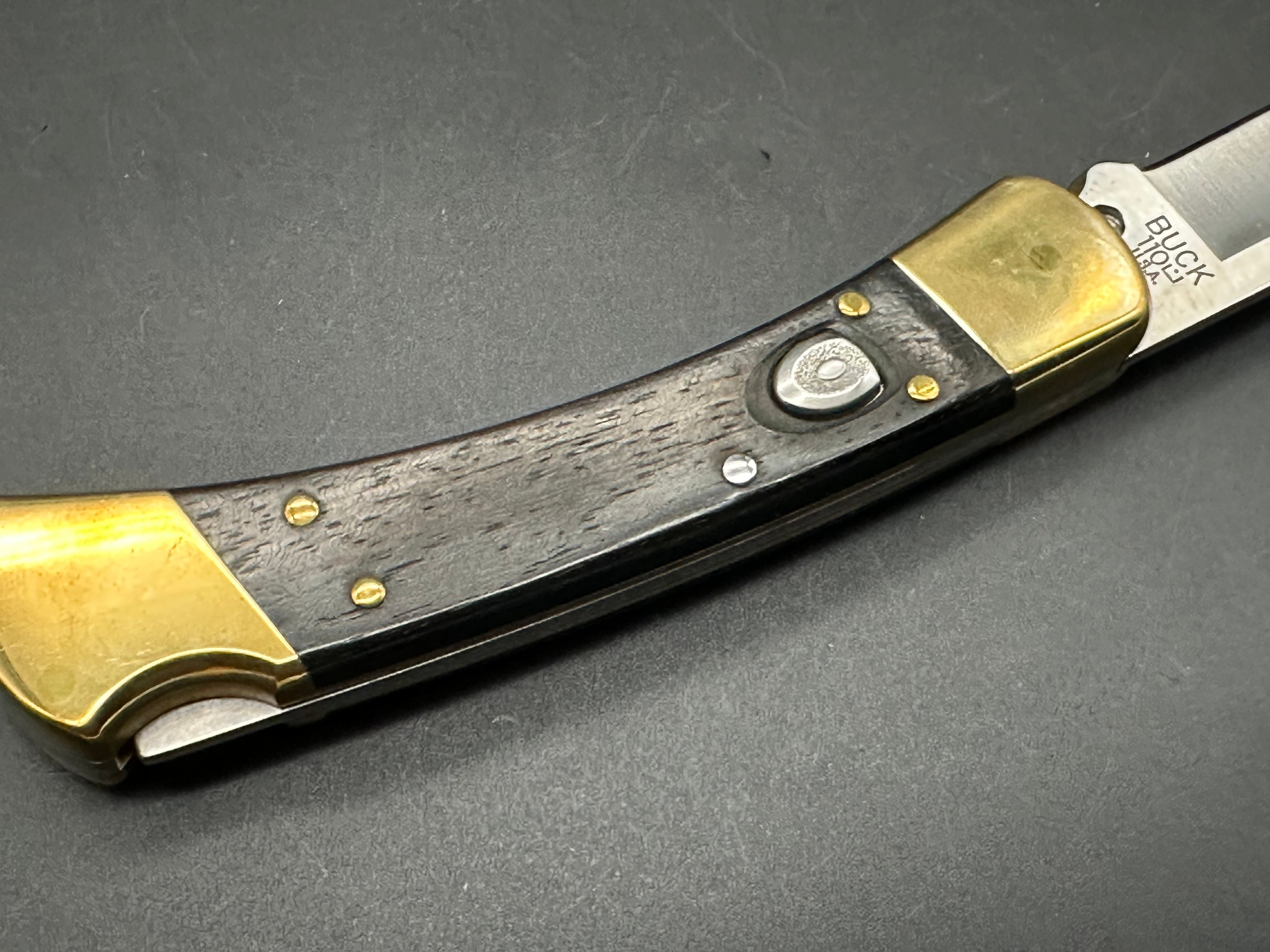 Buck 110 Automatic Folding Knife - Ebony Wood & Brass Handle, 420HC Stainless Steel Blade with Leather Sheath - Perfect for Hunting, Camping & Everyday Carry (EDC)