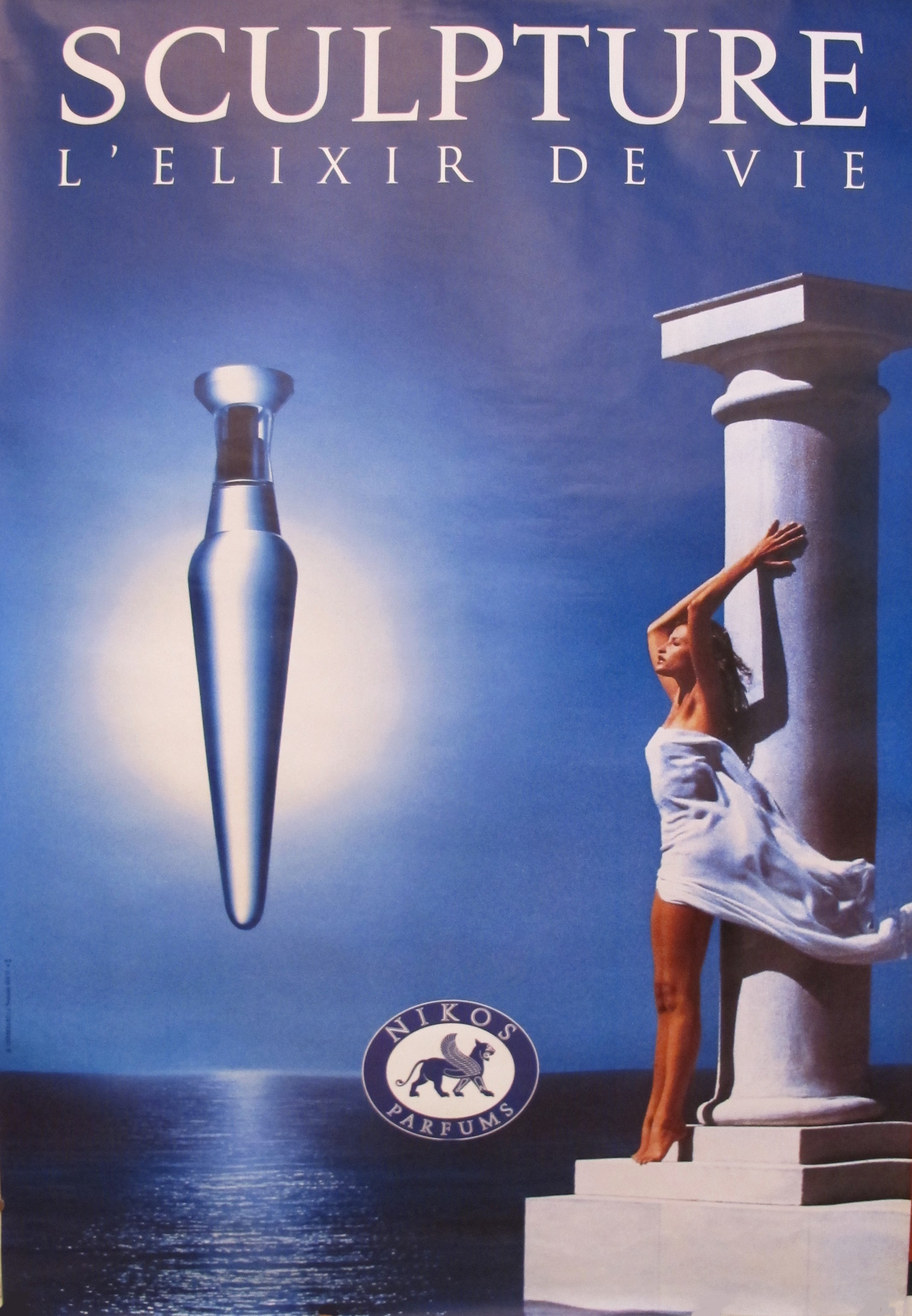 1994 Vintage Nikos Sculpture L'Elixir De Vie Perfume Advertisement Poster - Retro Fragrance Collectible for Home Decor & Perfume Lovers