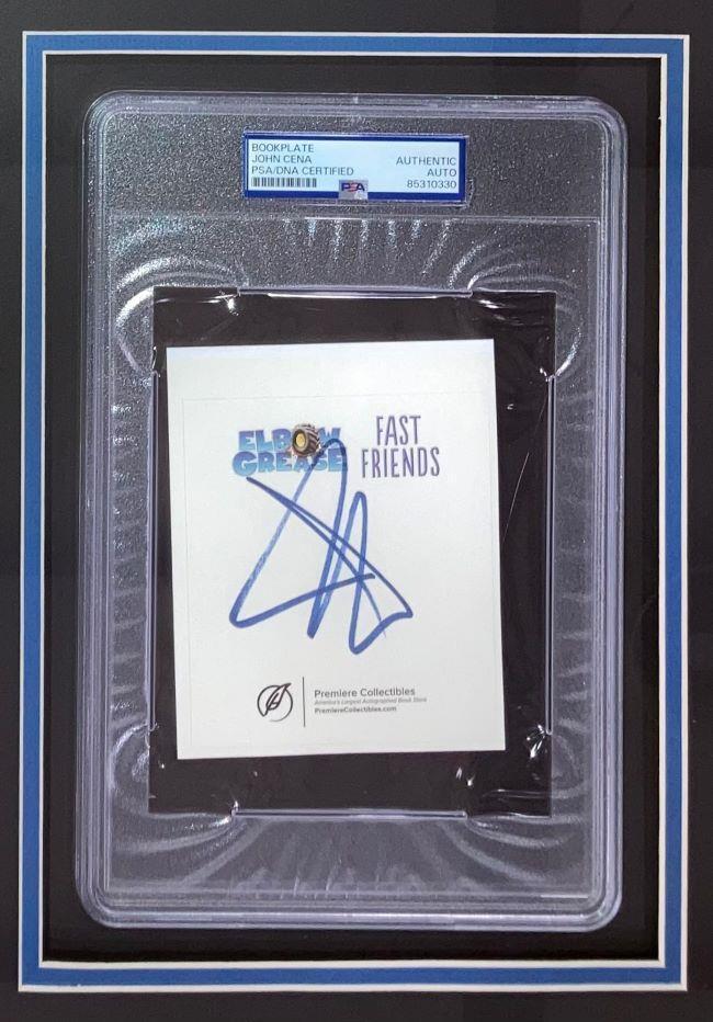 John Cena Autographed WWE Bookplate with Framed 8x10 vs The Rock Photo - PSA Certified Collectible for Wrestling Fans & Sports Memorabilia Display