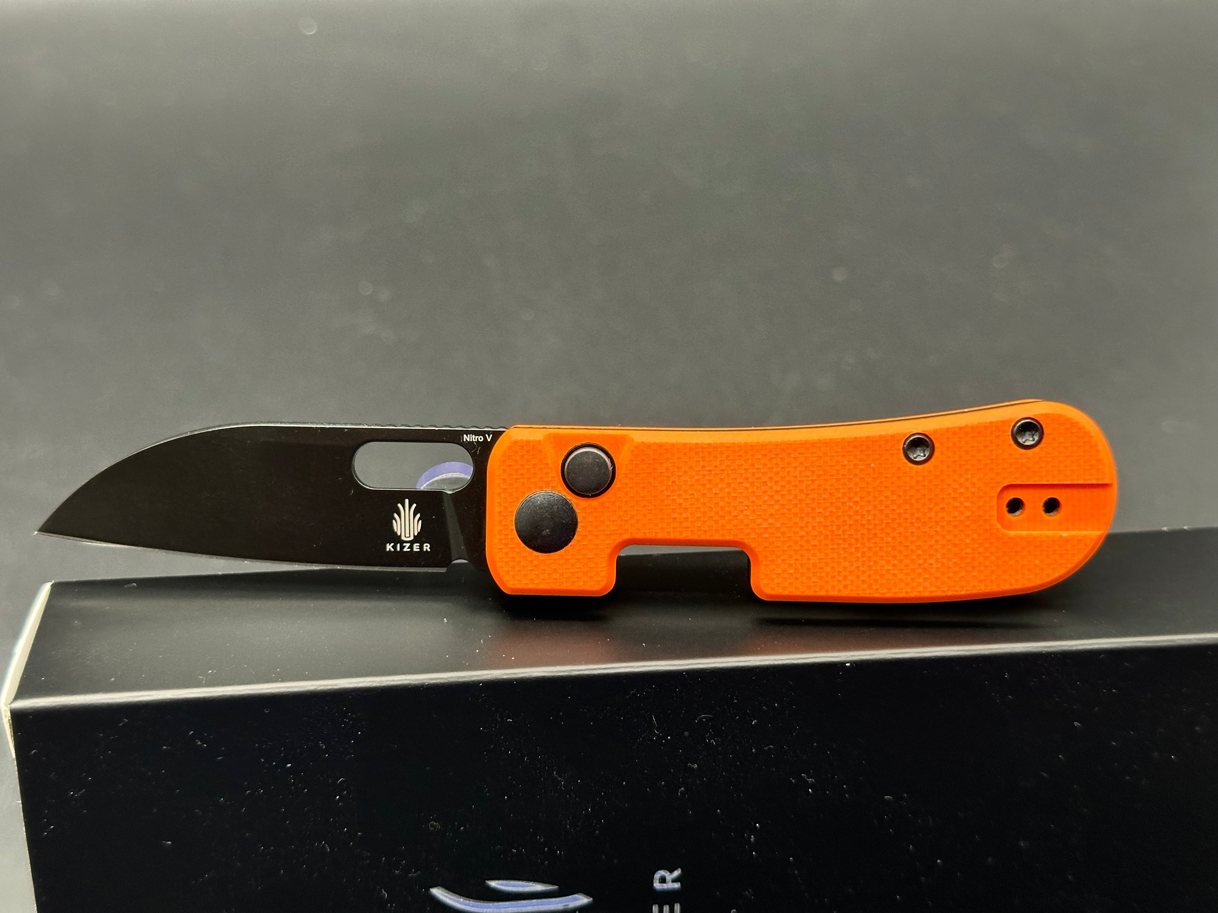 Kizer Banish Folding Knife - Nitro V Steel Blade, Button Lock, Orange Textured G10 Handle - EDC Pocket Knife for Outdoor, Camping & Everyday Carry
