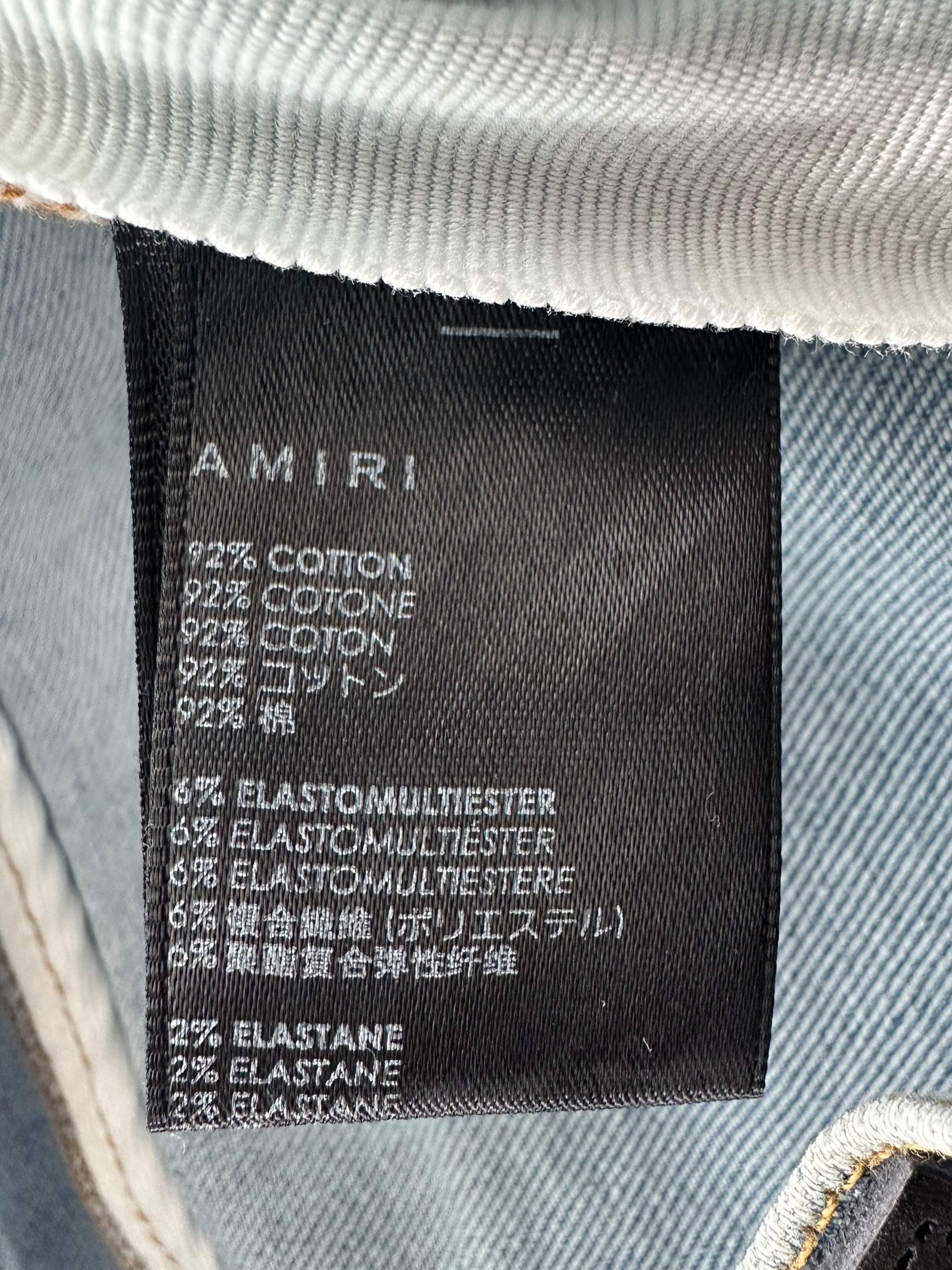 Amiri Light Indigo Camouflage Patch MX1 Jeans for Men - Premium Distressed Denim Pants with Camo Details | Perfect for Streetwear & Casual Outfits