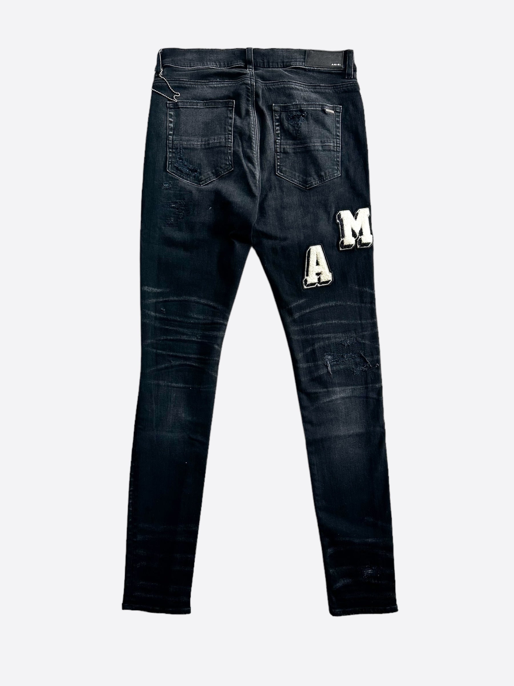 Amiri Faded Black & White Varsity Applique Distressed Jeans for Men - Vintage Style Ripped Denim Pants, Streetwear Fashion, Perfect for Casual Outfits & Night Out