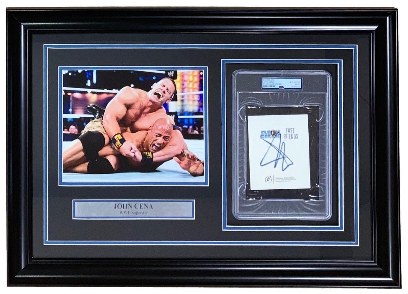 John Cena Autographed WWE Bookplate with Framed 8x10 vs The Rock Photo - PSA Certified Collectible for Wrestling Fans & Sports Memorabilia Display
