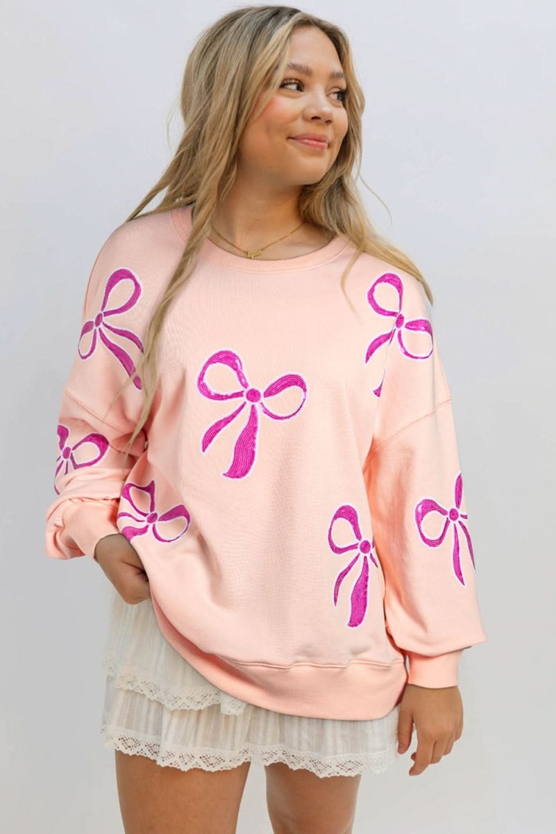 Stylish Apricot Pink Sequined Bowknot Drop Shoulder Oversized Sweatshirt for Women | Trendy Loose Fit Pullover | Perfect for Casual Outings, Parties & Date Nights