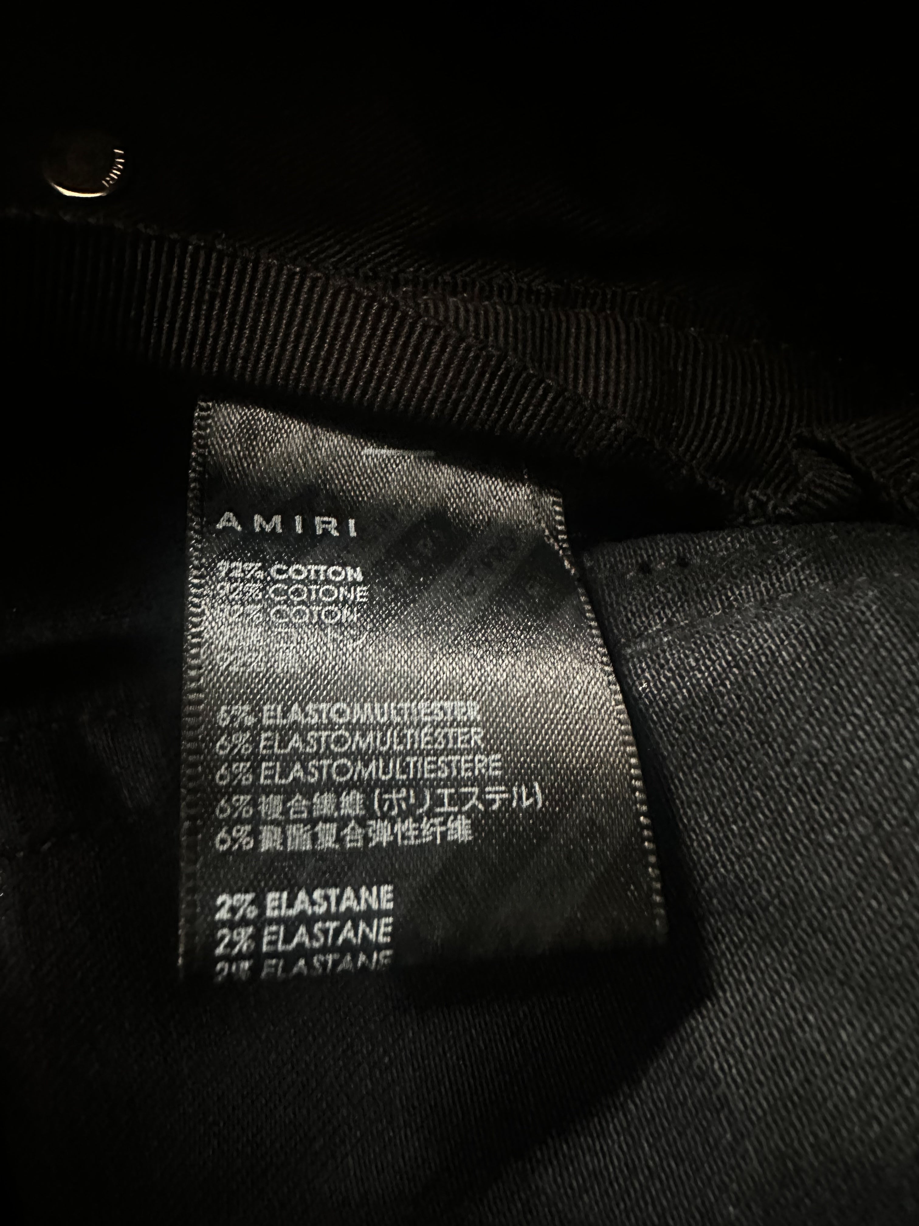Amiri Faded Black & White Varsity Applique Distressed Jeans for Men - Vintage Style Ripped Denim Pants, Streetwear Fashion, Perfect for Casual Outfits & Night Out