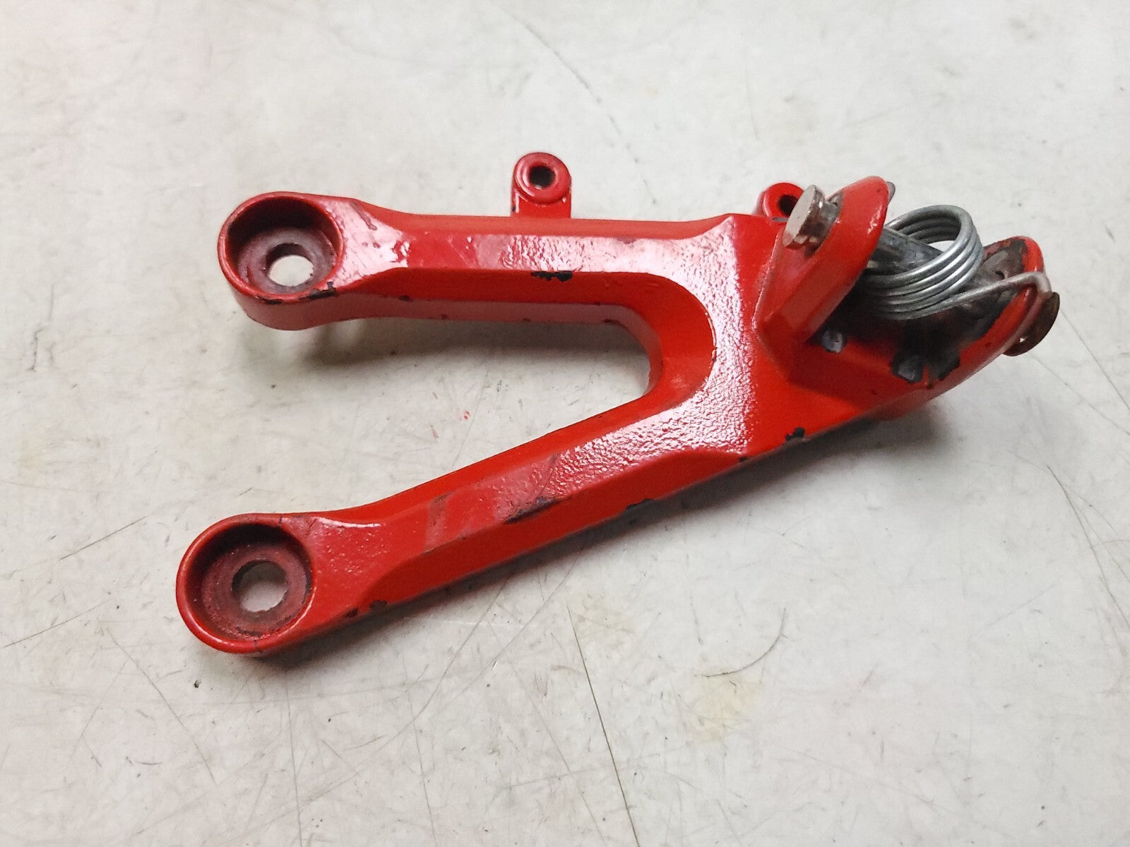 04-05 Honda CBR1000RR Foot Peg Bracket Left Side OEM Replacement Part - Perfect for Motorcycle Repair & Racing Upgrades